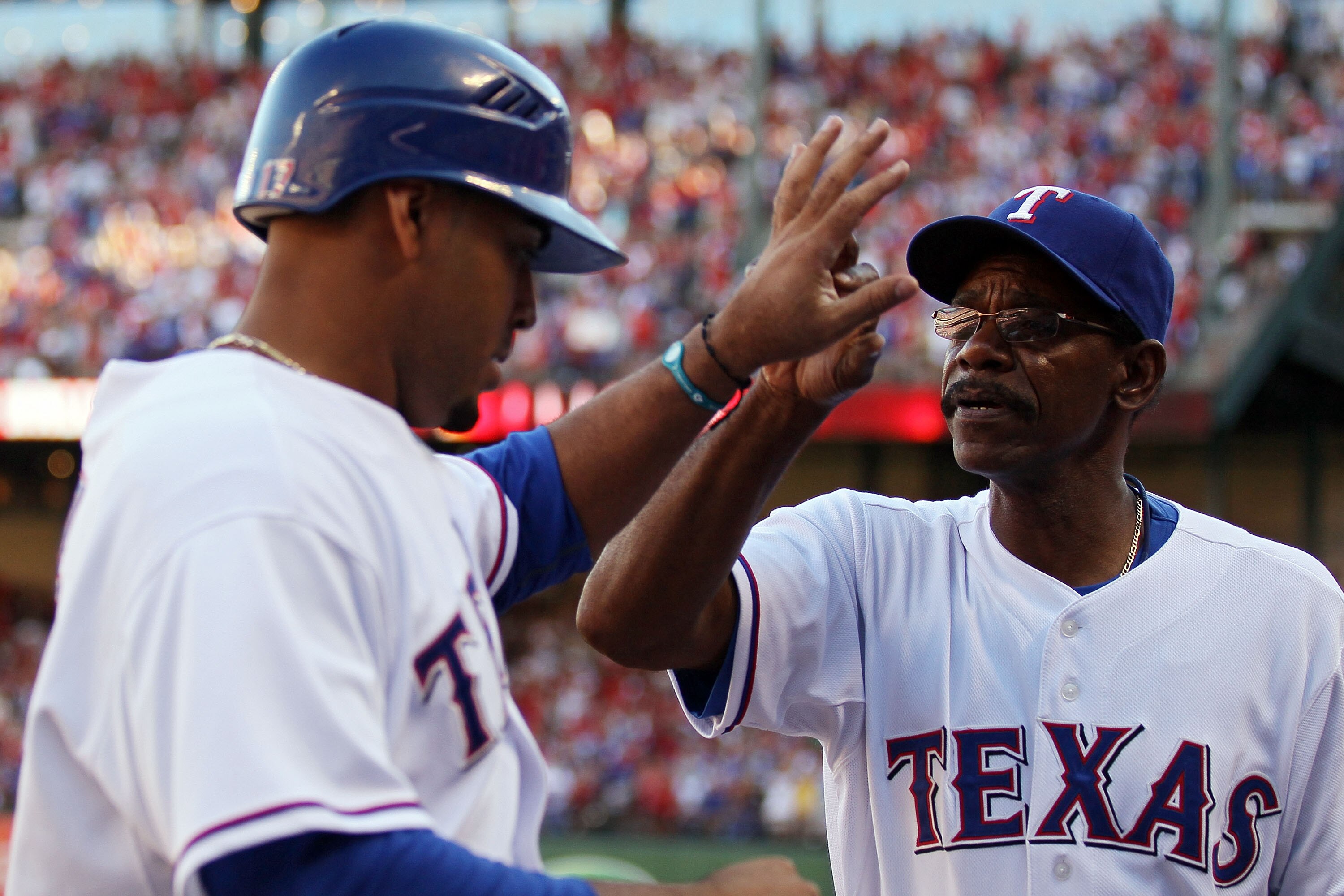 ARLINGTON, TX - OCTOBER 16:  Manager Ron Washington of the Texas Rangers congratulates Nelson Cruz #17 after Cruz scored in the bottom of the fifth inning against the New York Yankees in Game Two of the ALCS during the 2010 MLB Playoffs at Rangers Ballpar
