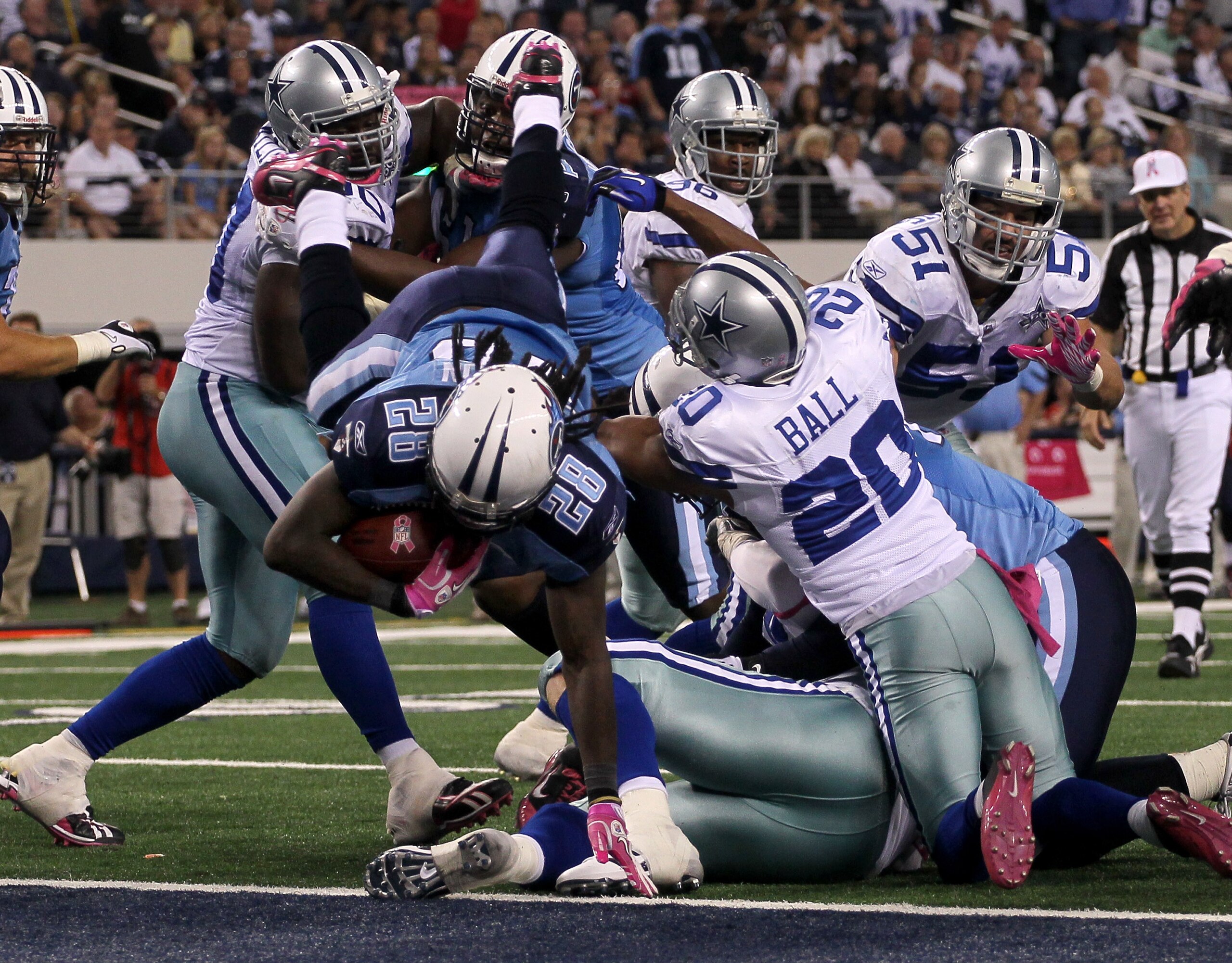 ARLINGTON, TX - OCTOBER 10:  Running back Chris Johnson #28 of the Tennessee Titans dives over the line to score the winning touchdown in the fourth quarter against the Dallas Cowboys at Cowboys Stadium on October 10, 2010 in Arlington, Texas.   The Titan