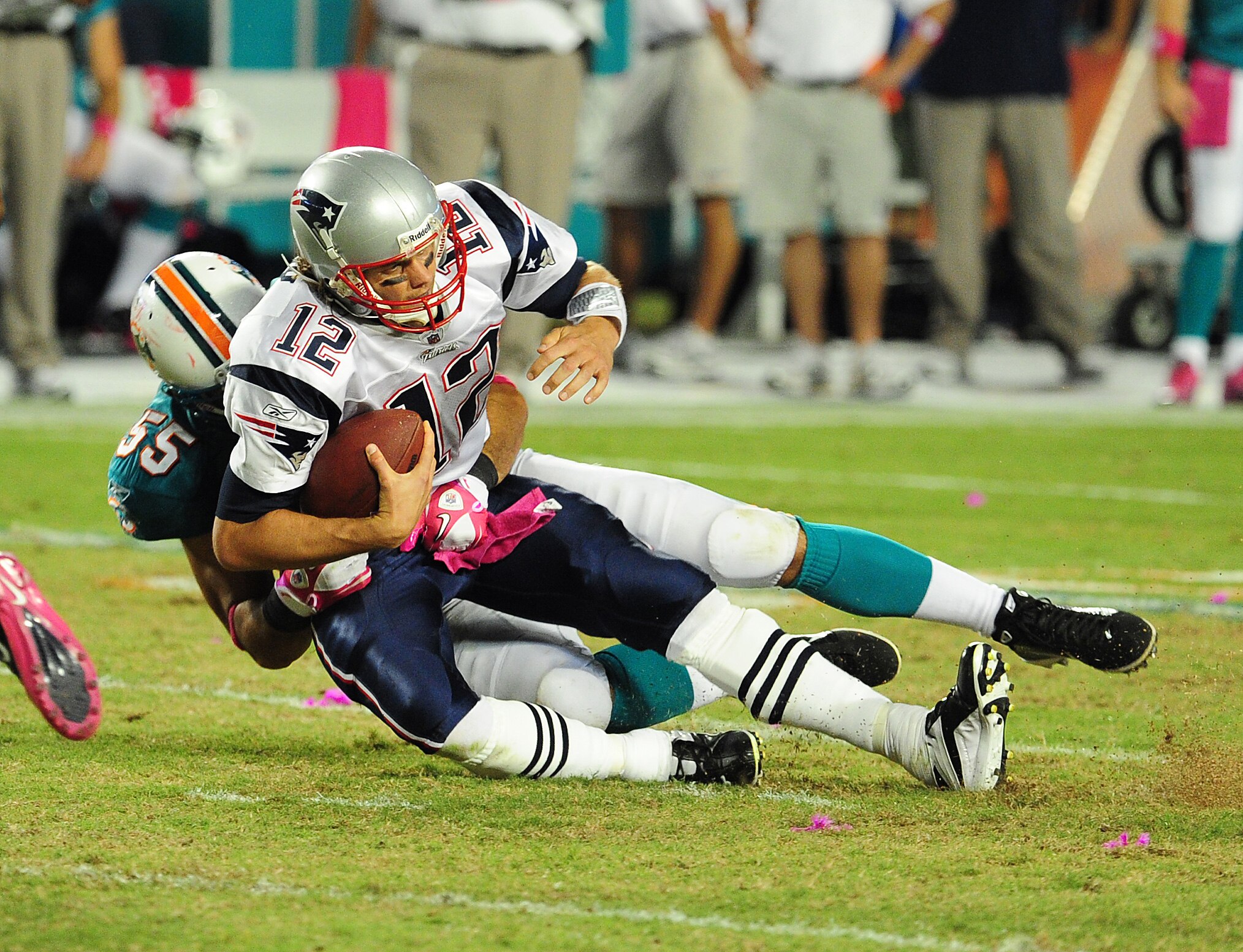 MIAMI - OCTOBER 4: Tom Brady #12 of the New England Patriots is sacked by Koa Misi #55 of the Miami Dolphins at Sun Life Field on October 4, 2010 in Miami, Florida. (Photo by Scott Cunningham/Getty Images)