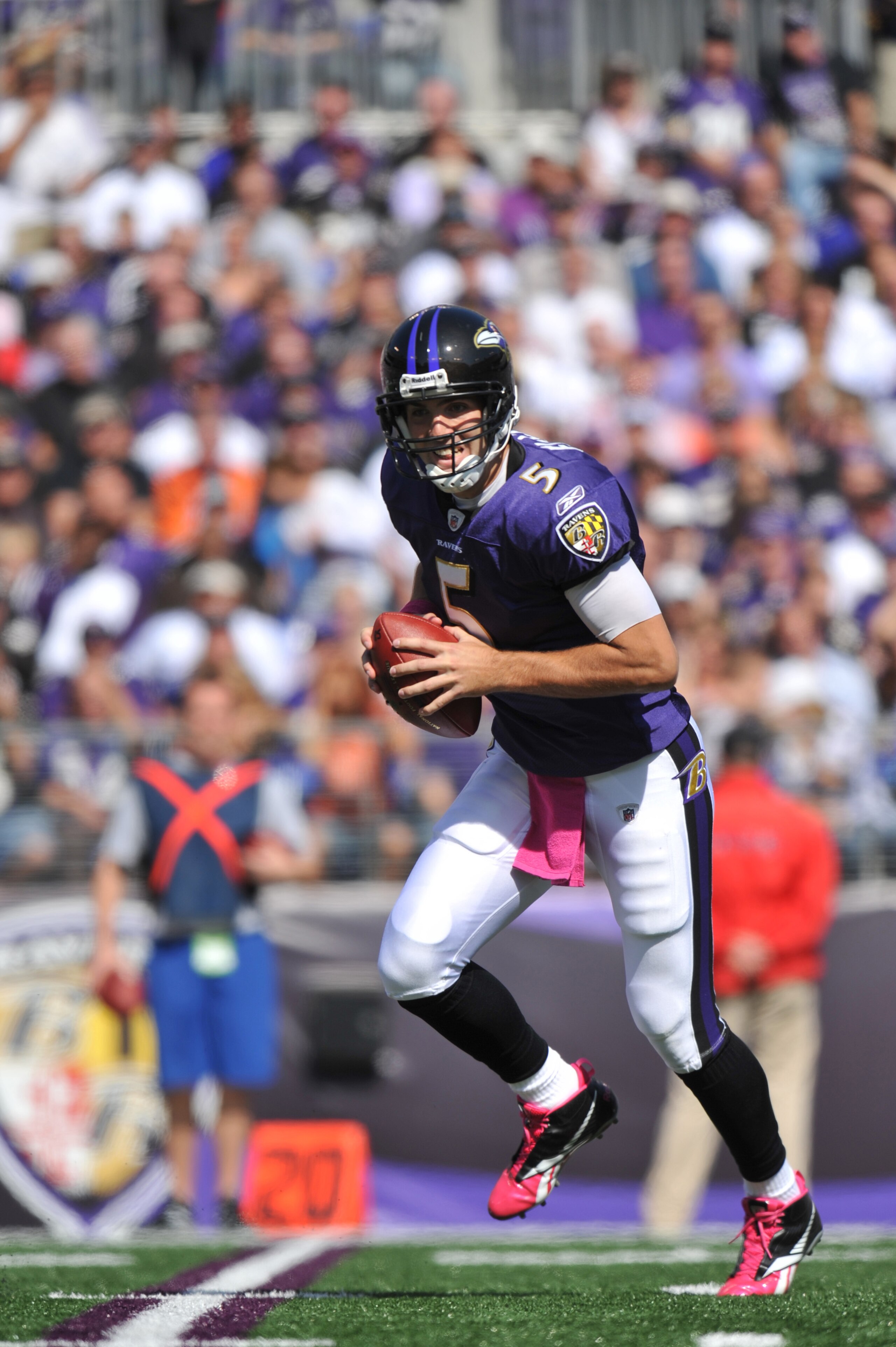BALTIMORE, MD - OCTOBER 10: Joe Flacco #5 of the Baltimore Ravens looks for a receiver during the game against the Denver Broncos at M&T Bank Stadium on October 10, 2010 in Baltimore, Maryland. Players wore pink in recognition of Breast Cancer Awareness M