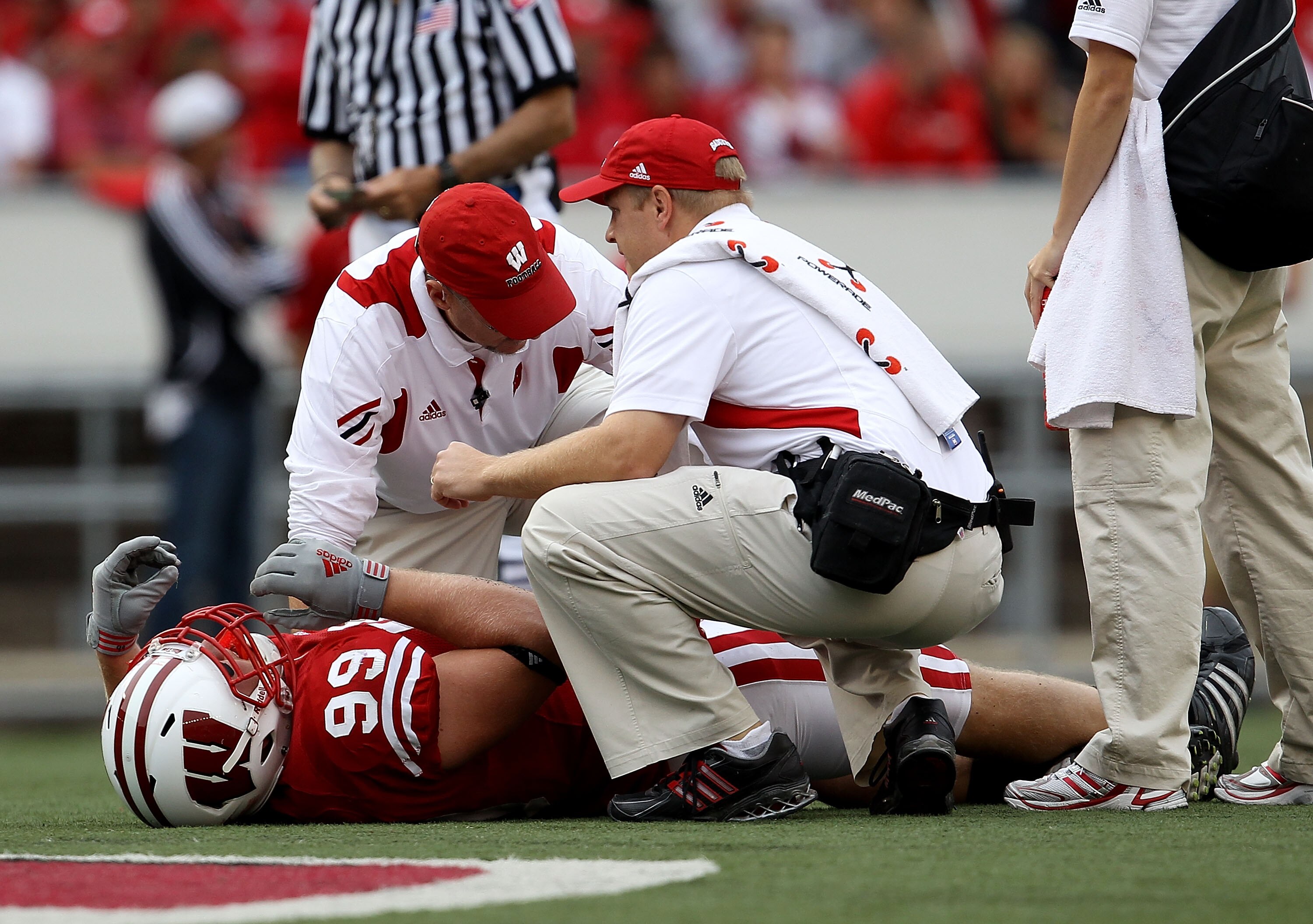 MADISON, WI - SEPTEMBER 18: J.J. Watt #99 of the Wisconsin Badgers is attended to by trainers after suffering an injury against the Arizona State Sun Devils at Camp Randall Stadium on September 18, 2010 in Madison, Wisconsin. Wisconsin defeated Arizona St