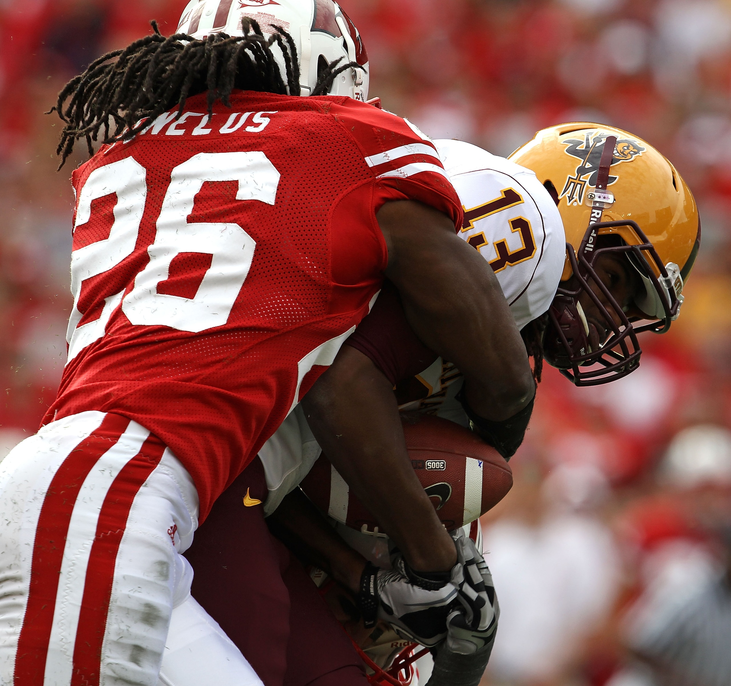 MADISON, WI - SEPTEMBER 18: George Bell #13 of the Arizona State Sun Devils is tackled by Antonio Fenelus #26 of the Wisconsin Badgers at Camp Randall Stadium on September 18, 2010 in Madison, Wisconsin. (Photo by Jonathan Daniel/Getty Images)