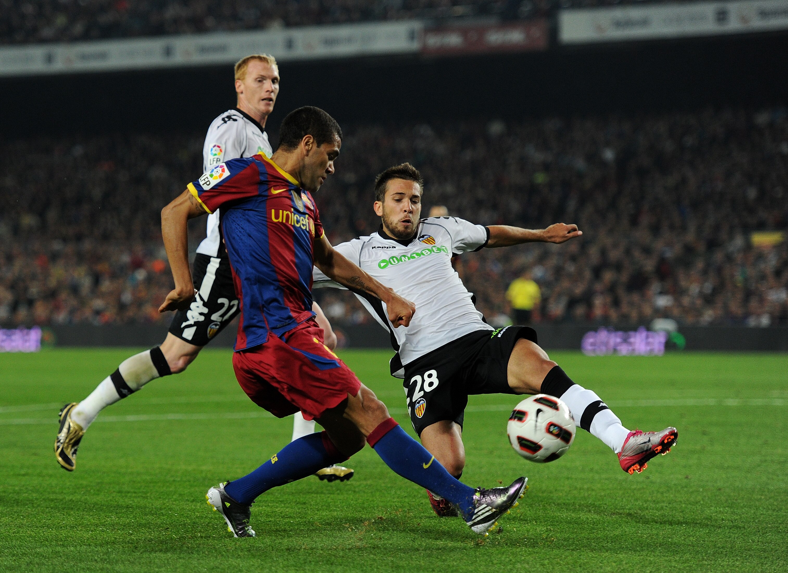 BARCELONA, SPAIN - OCTOBER 16:  Daniel Alves (L) of Barcelona tries to score past Jordi Alba of Valencia during the La Liga match between Barcelona and Valencia at the Camp Nou stadium on October 16, 2010 in Barcelona, Spain. Barcelona won the match 2-1. 