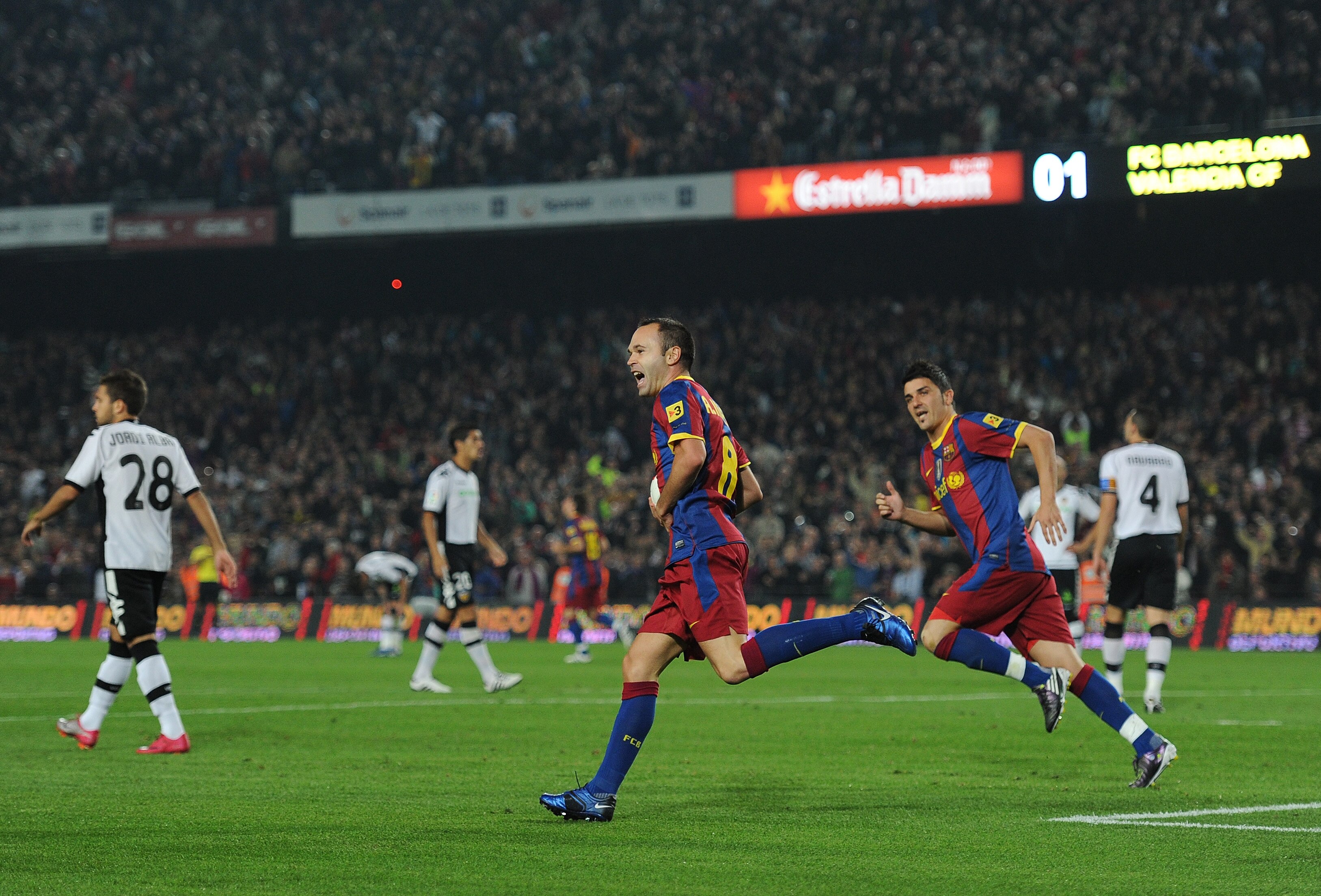 BARCELONA, SPAIN - OCTOBER 16:  Andres Iniesta (L) of Barcelona celebrates scoring his sides equalizing goal with his teammate David Villa during the La Liga match between Barcelona and Valencia at the Camp Nou stadium on October 16, 2010 in Barcelona, Sp