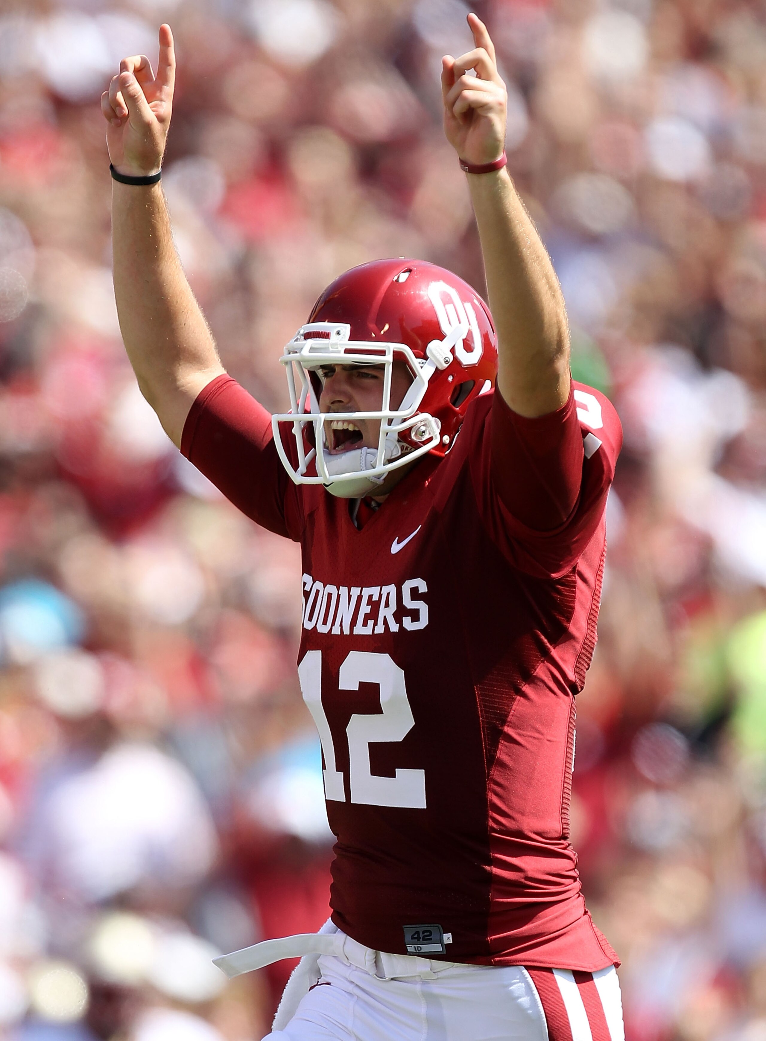 NORMAN, OK - SEPTEMBER 11:  Quarterback Landry Jones #12 of the Oklahoma Sooners celebrates a touchdown against the Florida State Seminoles in the first quarter at Gaylord Family Oklahoma Memorial Stadium on September 11, 2010 in Norman, Oklahoma.  (Photo