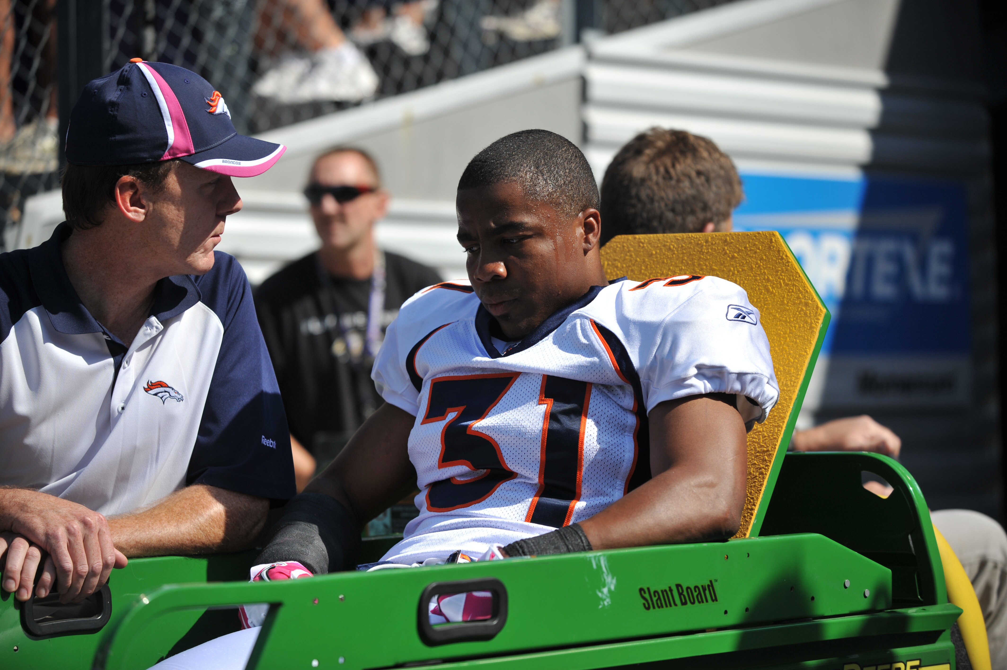 BALTIMORE, MD - OCTOBER 10: Darcel McBath #31 of the Denver Broncos is carted off the field after being injured during the game against the Baltimore Ravens at M&T Bank Stadium on October 10, 2010 in Baltimore, Maryland. Players wore pink in recognition o