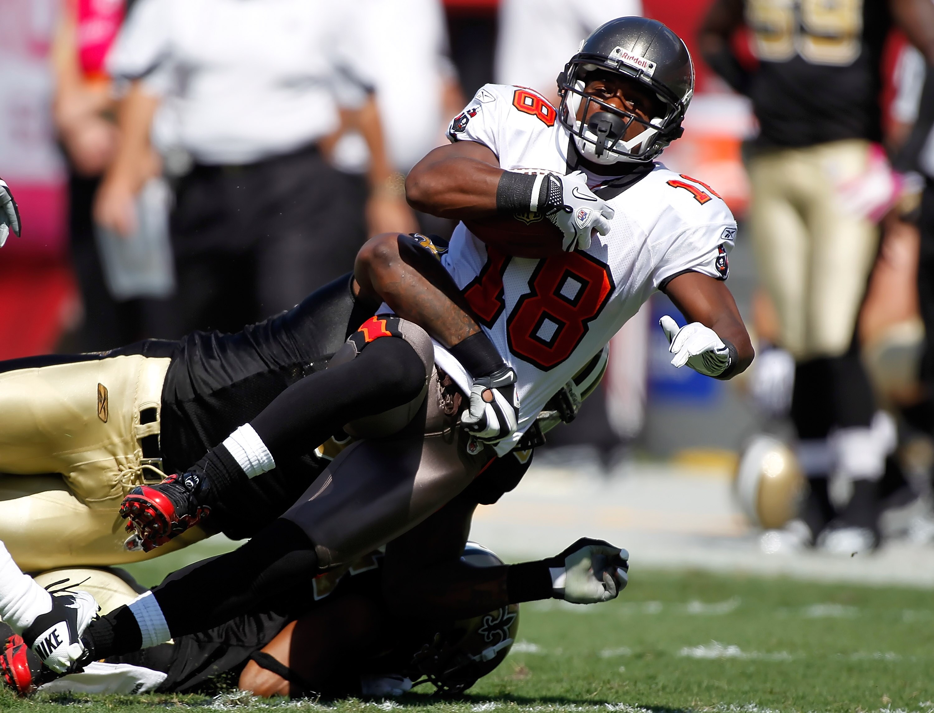 TAMPA, FL - OCTOBER 17:  Receiver Sammie Stroughter #18 of the Tampa Bay Buccaneers is tackled by linebacker Jonathan Vilma #51 of the New Orleans Saints during the game at Raymond James Stadium on October 17, 2010 in Tampa, Florida.  (Photo by J. Meric/G