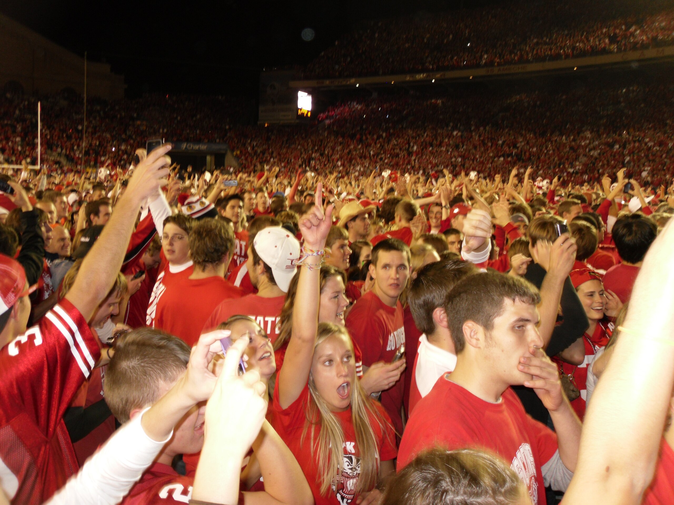 Badger fans congregate on the field following Wisconsin's win