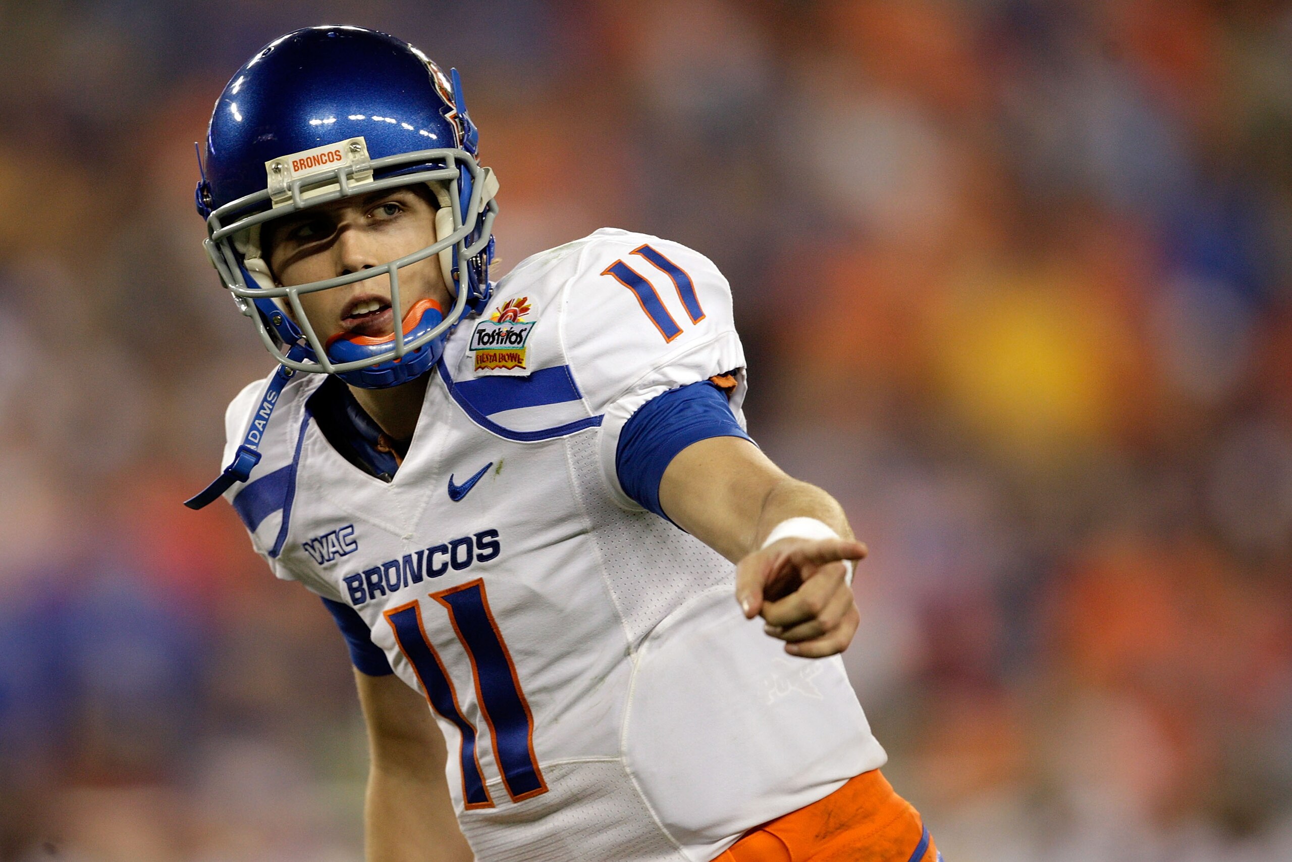 GLENDALE, AZ - JANUARY 04:  Quarterback Kellen Moore #11 of the Boise State Broncos points in the first half against the TCU Horned Frogs during the Tostitos Fiesta Bowl at the Universtity of Phoenix Stadium on January 4, 2010 in Glendale, Arizona.  (Phot