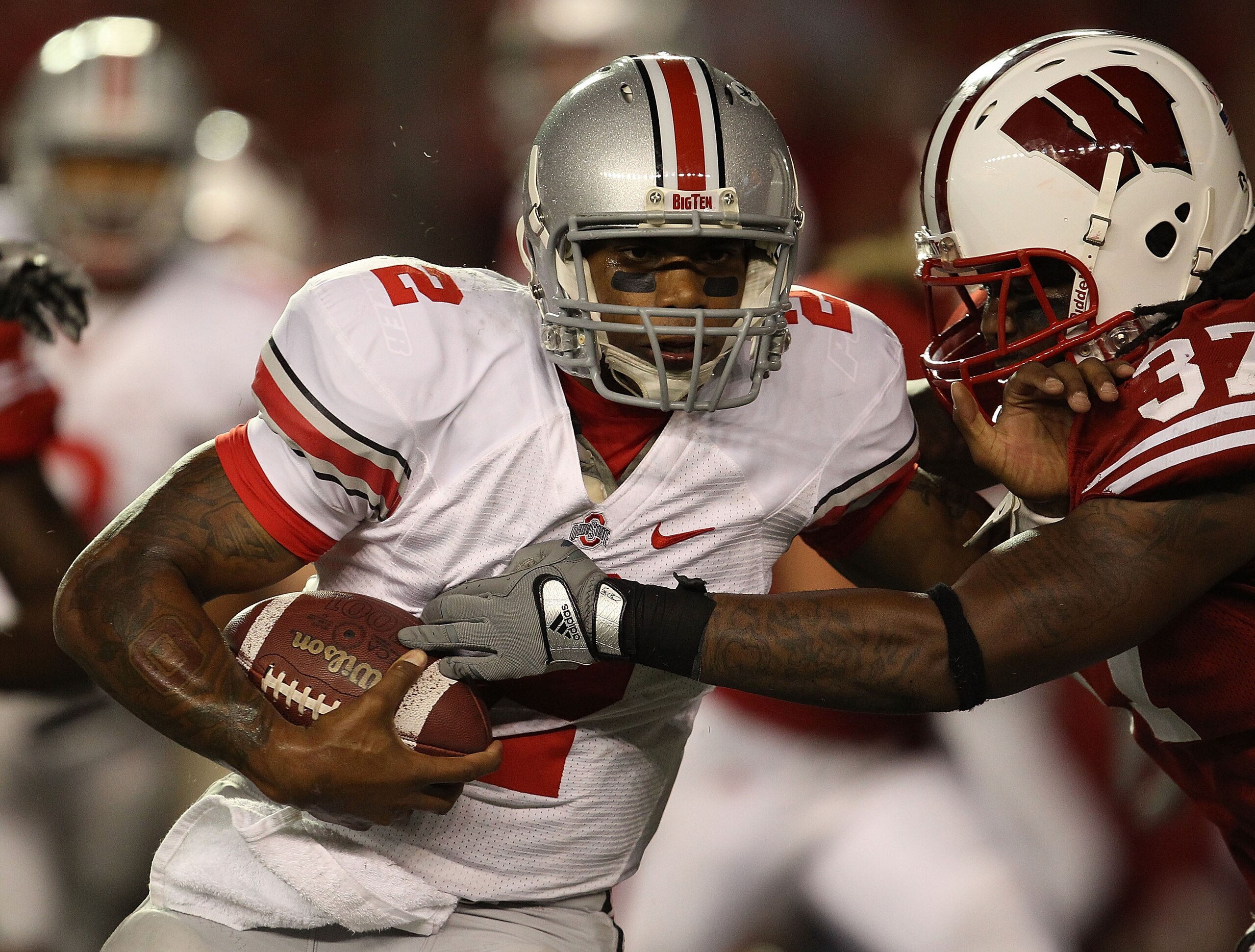 MADISON, WI - OCTOBER 16: Terrelle Pryor #2 of the Ohio State Buckeyes rushes against Kevin Claxton #37 of the Wisconsin Badgers at Camp Randall Stadium on October 16, 2010 in Madison, Wisconsin. Wisconsin defeated Ohio State 31-18.  (Photo by Jonathan Da