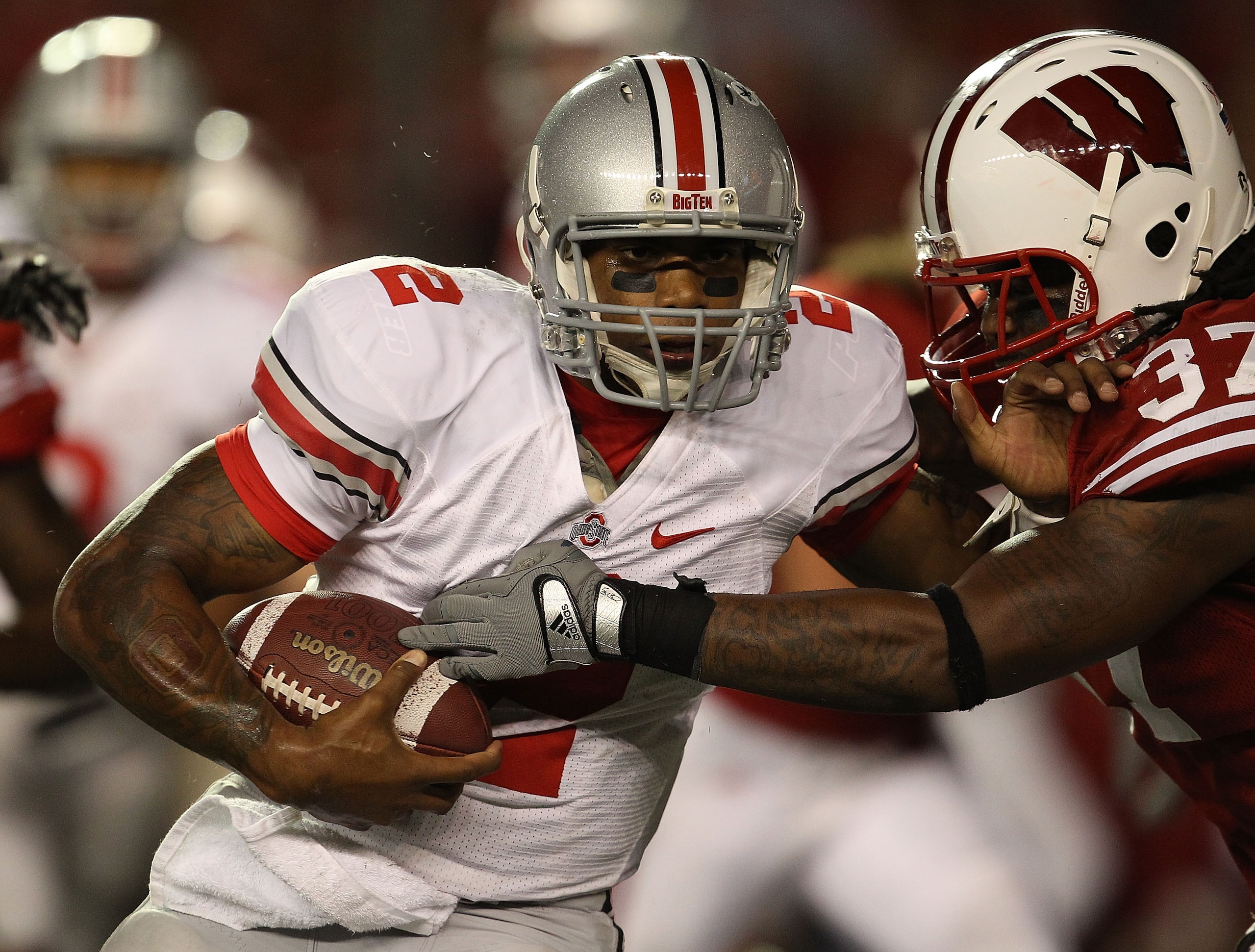 MADISON, WI - OCTOBER 16: Terrelle Pryor #2 of the Ohio State Buckeyes rushes against Kevin Claxton #37 of the Wisconsin Badgers at Camp Randall Stadium on October 16, 2010 in Madison, Wisconsin. Wisconsin defeated Ohio State 31-18.  (Photo by Jonathan Da