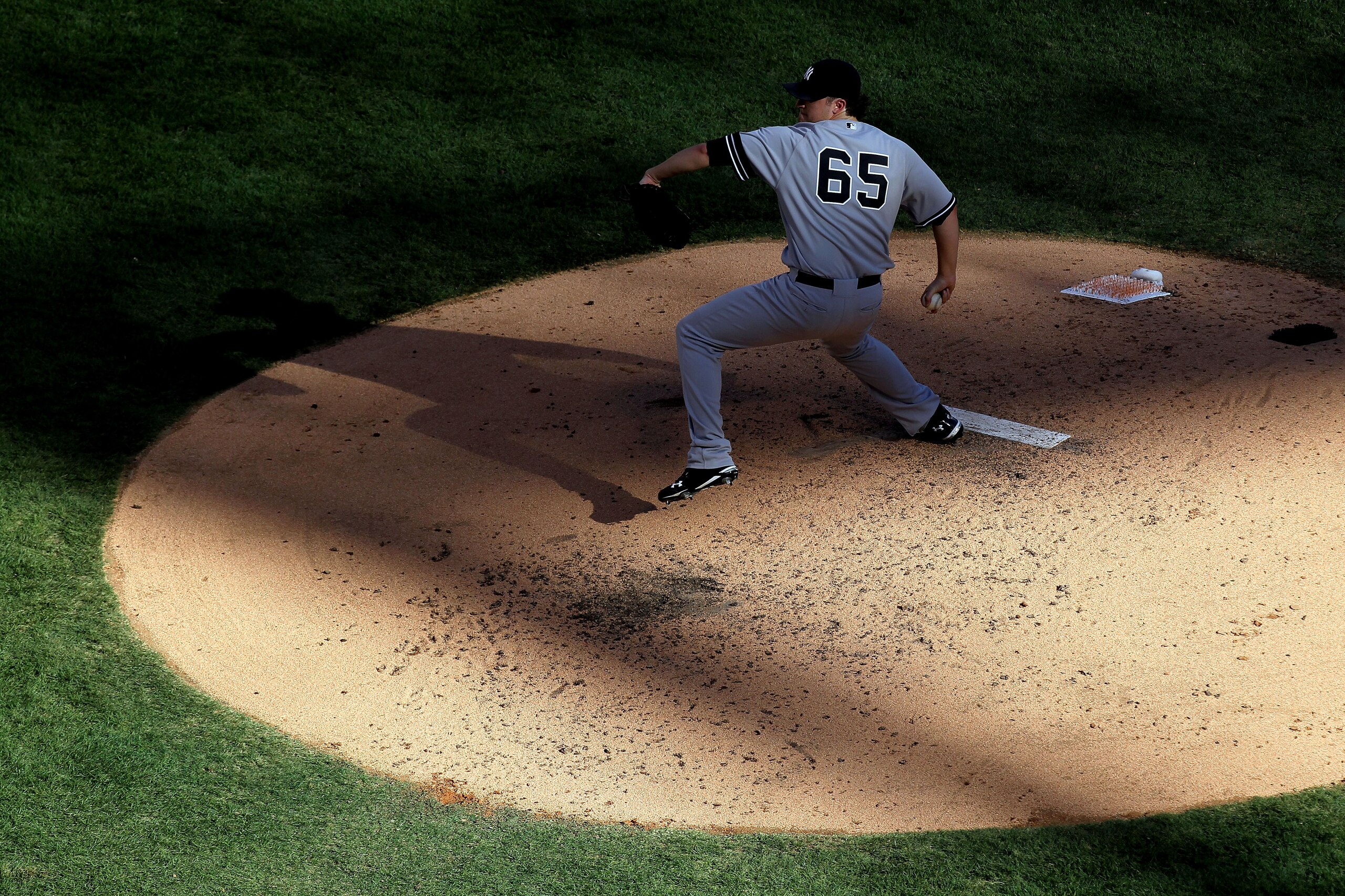 ARLINGTON, TX - OCTOBER 16:  Phil Hughes #65 of the New York Yankees pitches against the Texas Rangers in Game Two of the ALCS during the 2010 MLB Playoffs at Rangers Ballpark in Arlington on October 16, 2010 in Arlington, Texas.  (Photo by Ronald Martine