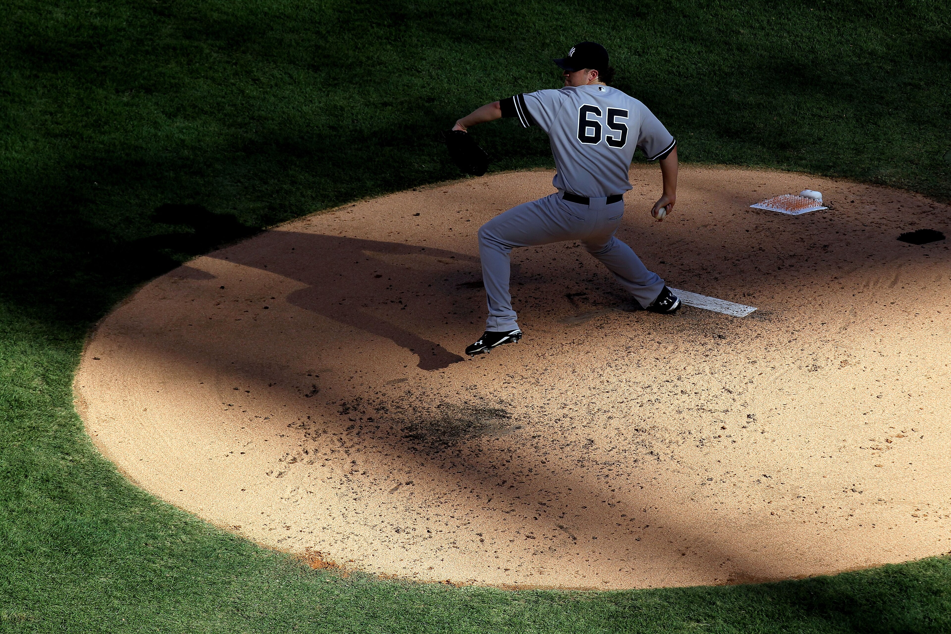 ARLINGTON, TX - OCTOBER 16:  Phil Hughes #65 of the New York Yankees pitches against the Texas Rangers in Game Two of the ALCS during the 2010 MLB Playoffs at Rangers Ballpark in Arlington on October 16, 2010 in Arlington, Texas.  (Photo by Ronald Martine