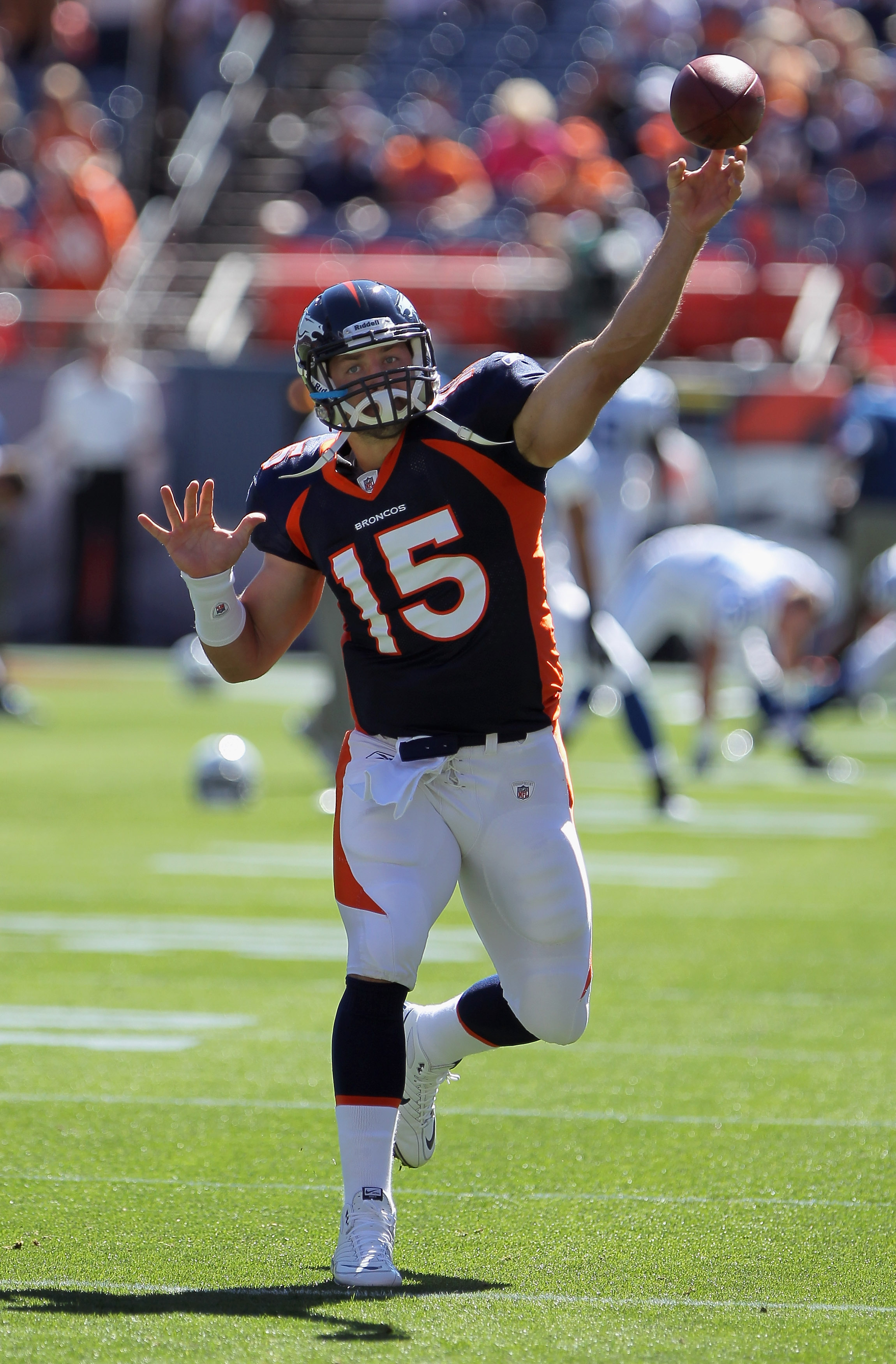 DENVER - SEPTEMBER 26:  Quarterback Tim Tebow #15 of the Denver Broncos warms up prior to facing the Indianapolis Colts at INVESCO Field at Mile High on September 26, 2010 in Denver, Colorado. The Colts defeated the Broncos 27-13.  (Photo by Doug Pensinge