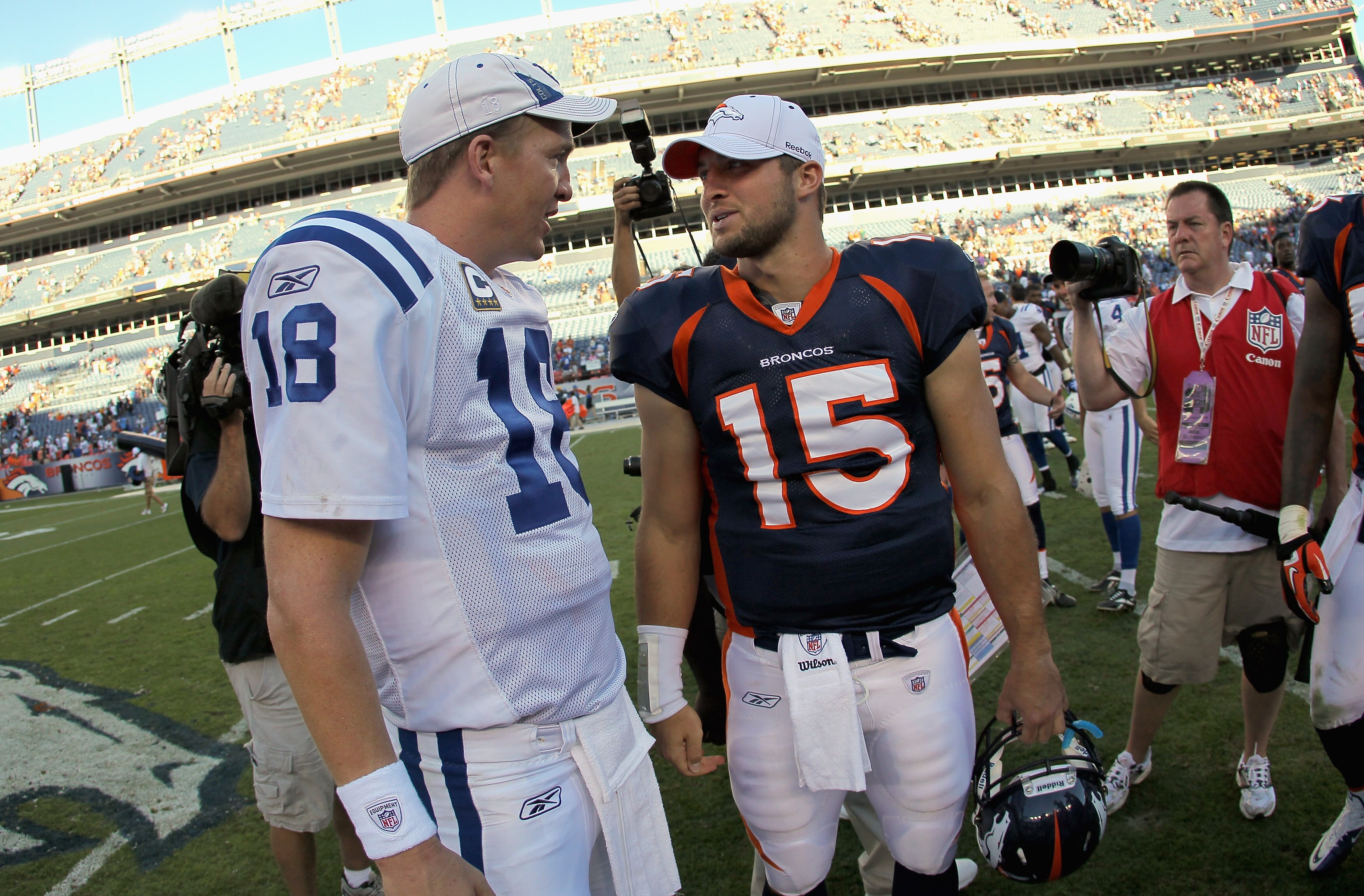 DENVER - SEPTEMBER 26:  Quarterback Peyton Manning #18 of the Indianapolis Colts and quarterback Tim Tebow #15 of the Denver Broncos meet at midfield after the game at INVESCO Field at Mile High on September 26, 2010 in Denver, Colorado. The Colts defeate