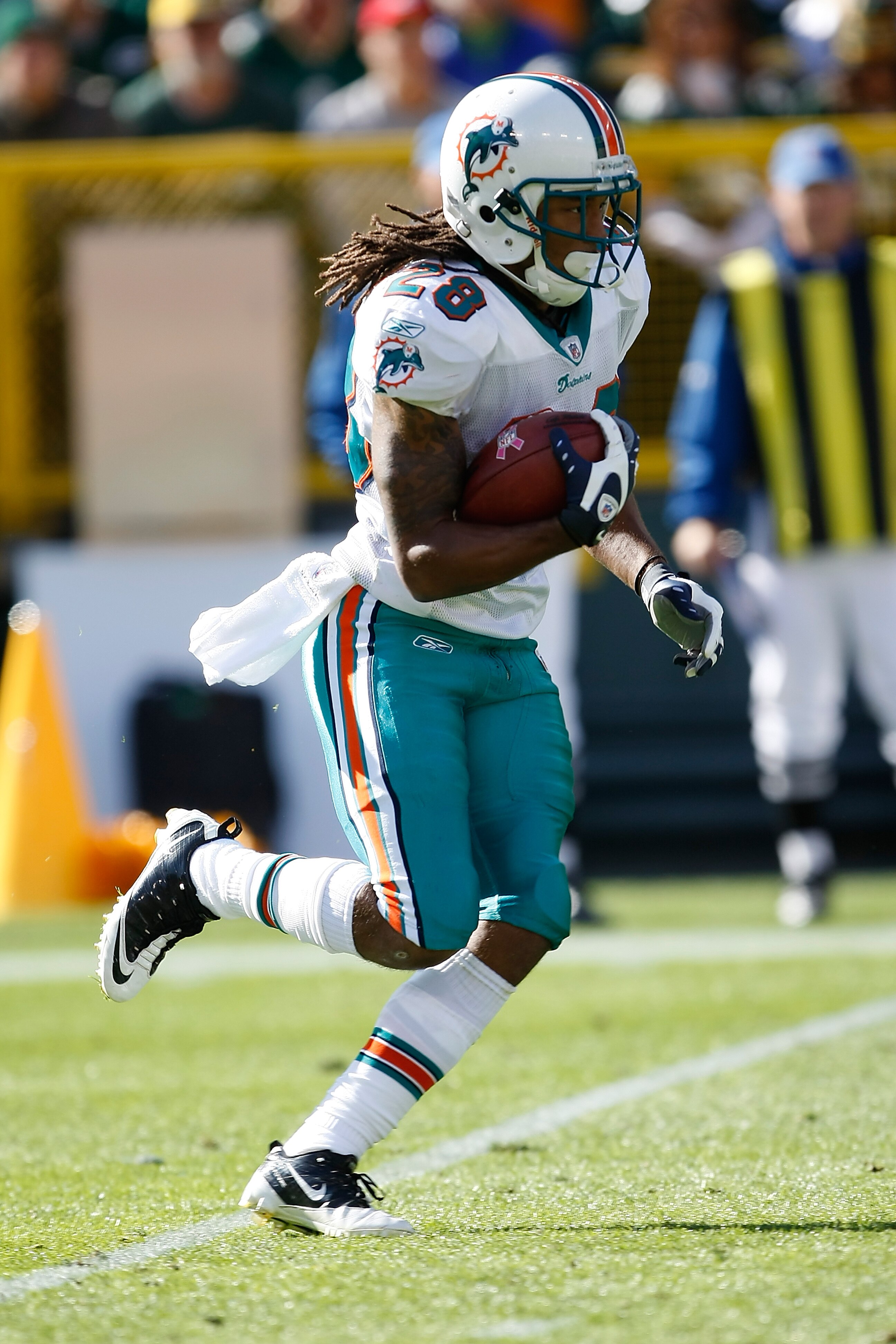 GREEN BAY, WI - OCTOBER 17: Nolan Carroll #28 of the Miami Dolphins runs against the Green Bay Packers at Lambeau Field on October 17, 2010 in Green Bay, Wisconsin. The Dolphins defeated the Packers 23-20 in overtime. (Photo by Scott Boehm/Getty Images)