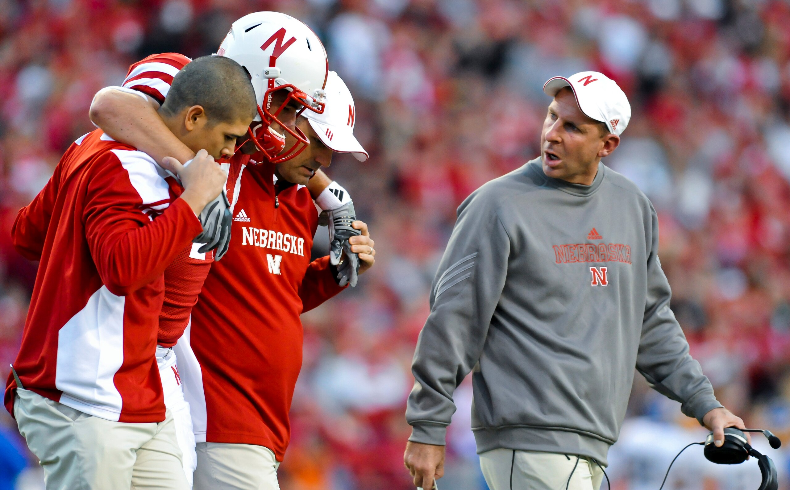 LINCOLN, NEBRASKA - SEPTEMBER 25: Nebraksa Cornhusker head coach Bo Pelini (R) checks on injured Nebraska Cornhuskers tight end Mike McNeill #44 their game against the South Dakota State Jackrabbits at Memorial Stadium on September 25, 2010 in Lincoln, Ne LINCOLN, NEBRASKA - SEPTEMBER 25: Nebraksa Cornhusker head coach Bo Pelini (R) checks on injured Nebraska Cornhuskers tight end Mike McNeill #44 their game against the South Dakota State Jackrabbits at Memorial Stadium on September 25, 2010 in Lincoln, Ne