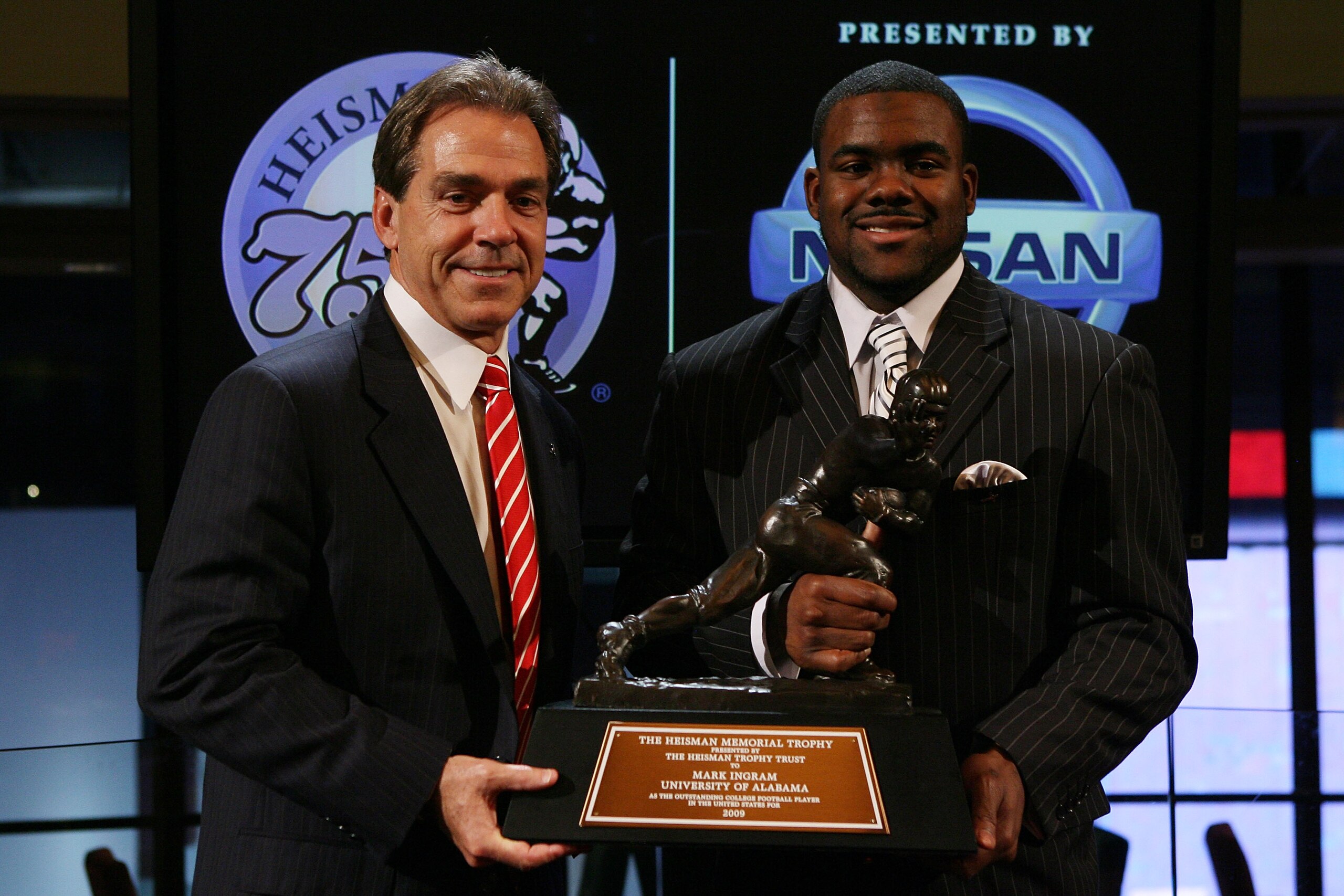 NEW YORK - DECEMBER 12: Running back Mark Ingram (R) #22 of the Alabama Crimson Tide poses with Head coach Nick Saban (L) and the Heisman Trophy during a press conference after being named the 75th Heisman Trophy winner at the Marriott Marquis on December
