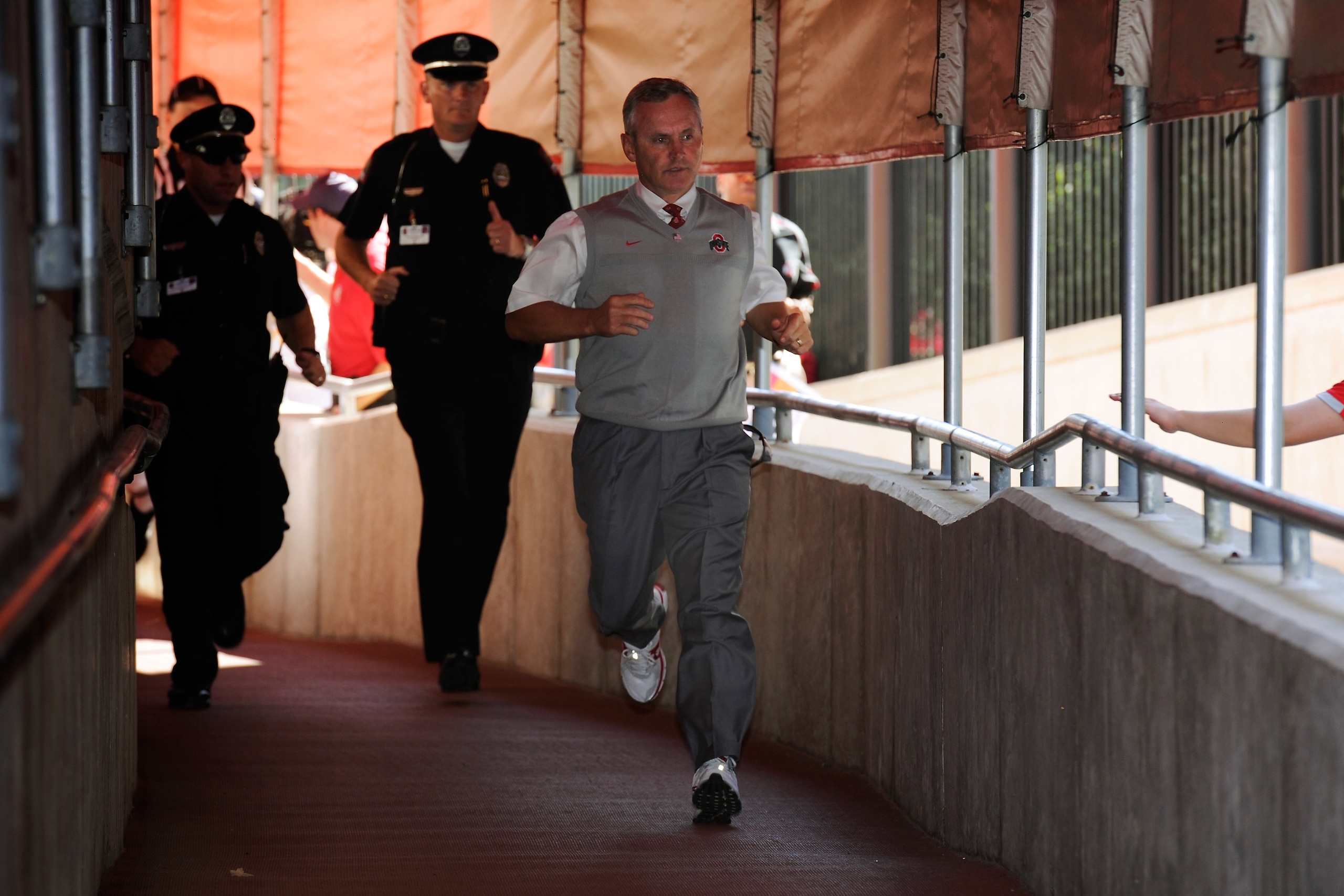 COLUMBUS, OH - OCTOBER 9:  Head coach Jim Tressel of the Ohio State Buckeyes runs down the tunnel to the field ahead of his team before a game against the Indiana Hoosiers at Ohio Stadium on October 9, 2010 in Columbus, Ohio.  (Photo by Jamie Sabau/Getty