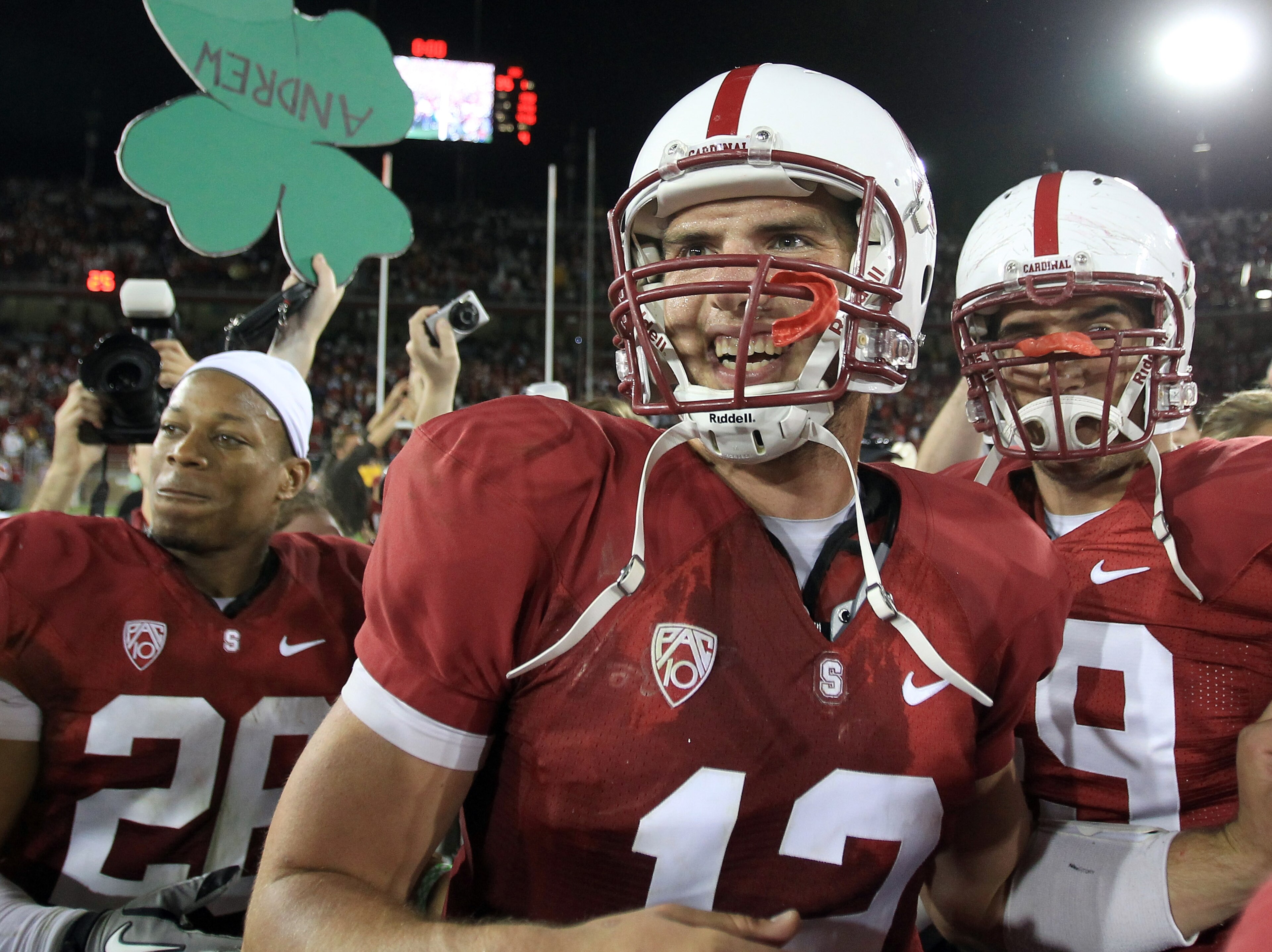 PALO ALTO, CA - OCTOBER 09:  Andrew Luck #12 of the Stanford Cardinal is surrounded by teammates and fans after they beat the USC Trojans 37-35 at Stanford Stadium on October 9, 2010 in Palo Alto, California.  (Photo by Ezra Shaw/Getty Images)