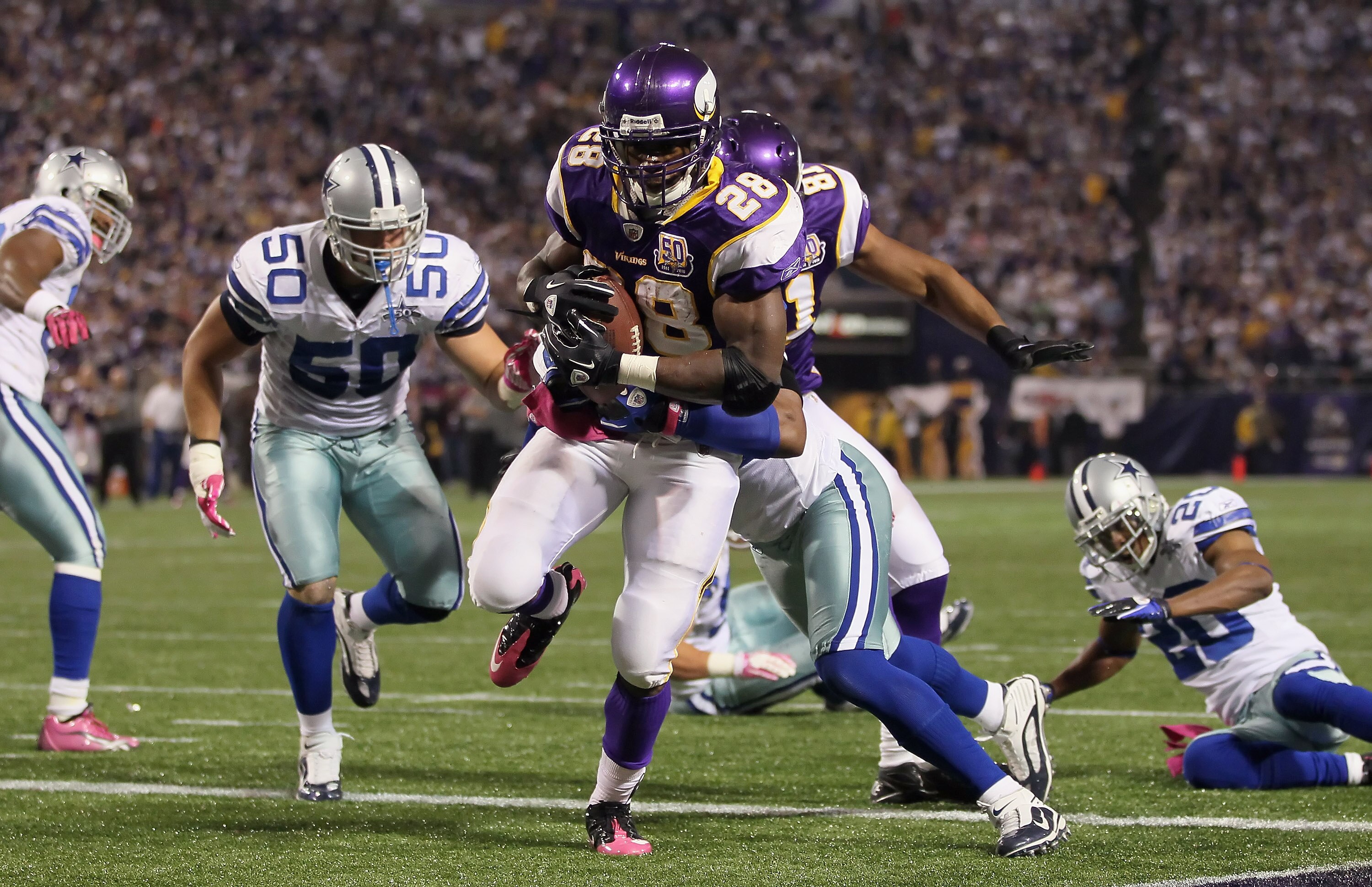 MINNEAPOLIS - OCTOBER 17:  Running back Adrian Peterson #29 of the Minnesota Vikings runs into the end zone for a touchdown against the Dallas Cowboys during the third quarter at Mall of America Field on October 17, 2010 in Minneapolis, Minnesota.  The Vi