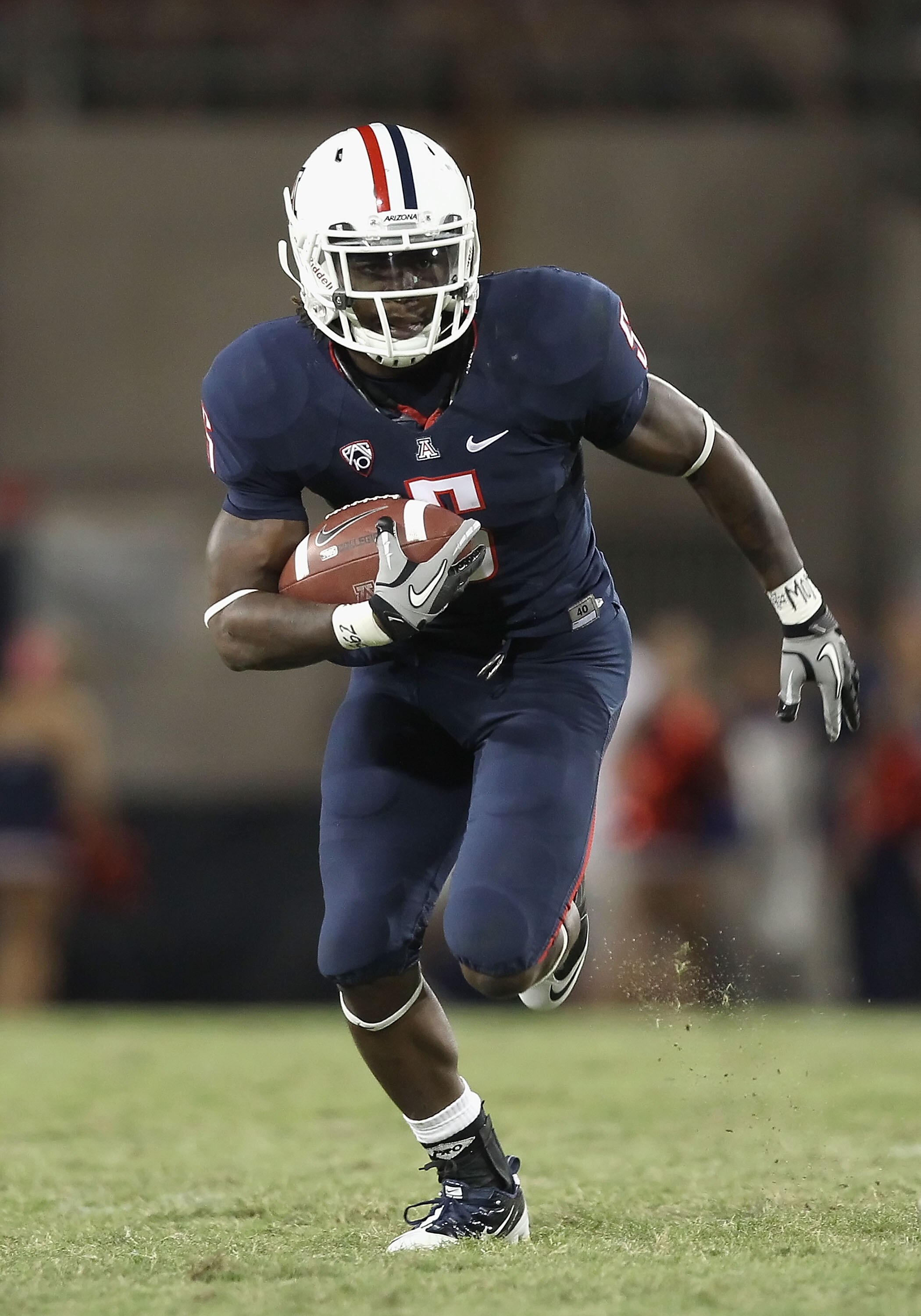 TUCSON, AZ - OCTOBER 09:  Runningback Nic Grigsby #5 of the Arizona Wildcats runs with the football during the college football game against the Oregon State Beavers at Arizona Stadium on October 9, 2010 in Tucson, Arizona. The Beavers defeated the Wildca