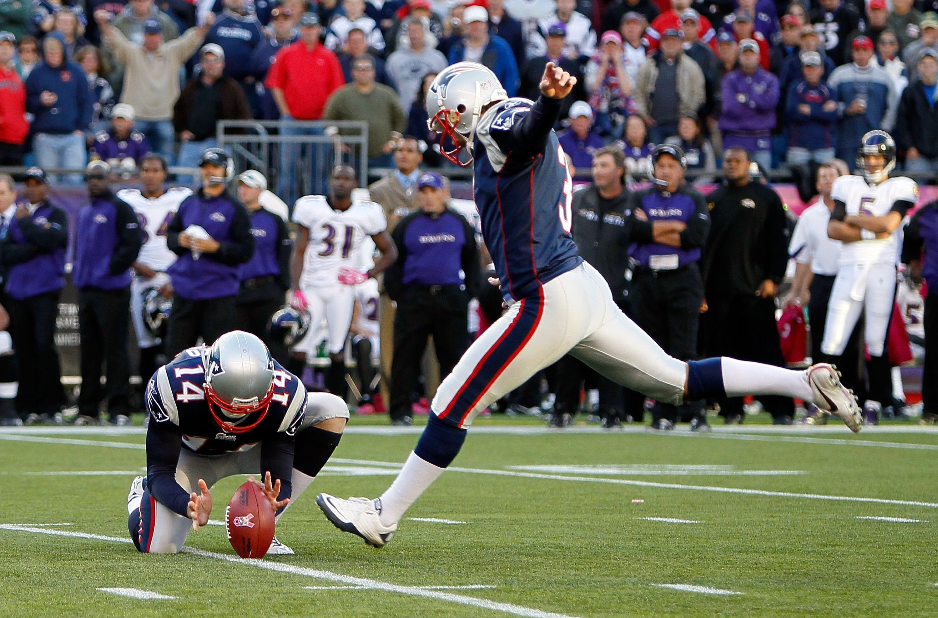 FOXBORO, MA - OCTOBER 17:  Stephen Gostkowski #3 of the New England Patriots kick the game winning field goal as Joe Flacco #5 of the Baltimore Ravens watches from the sidelines at Gillette Stadium on October 17, 2010 in Foxboro, Massachusetts. The Patrio