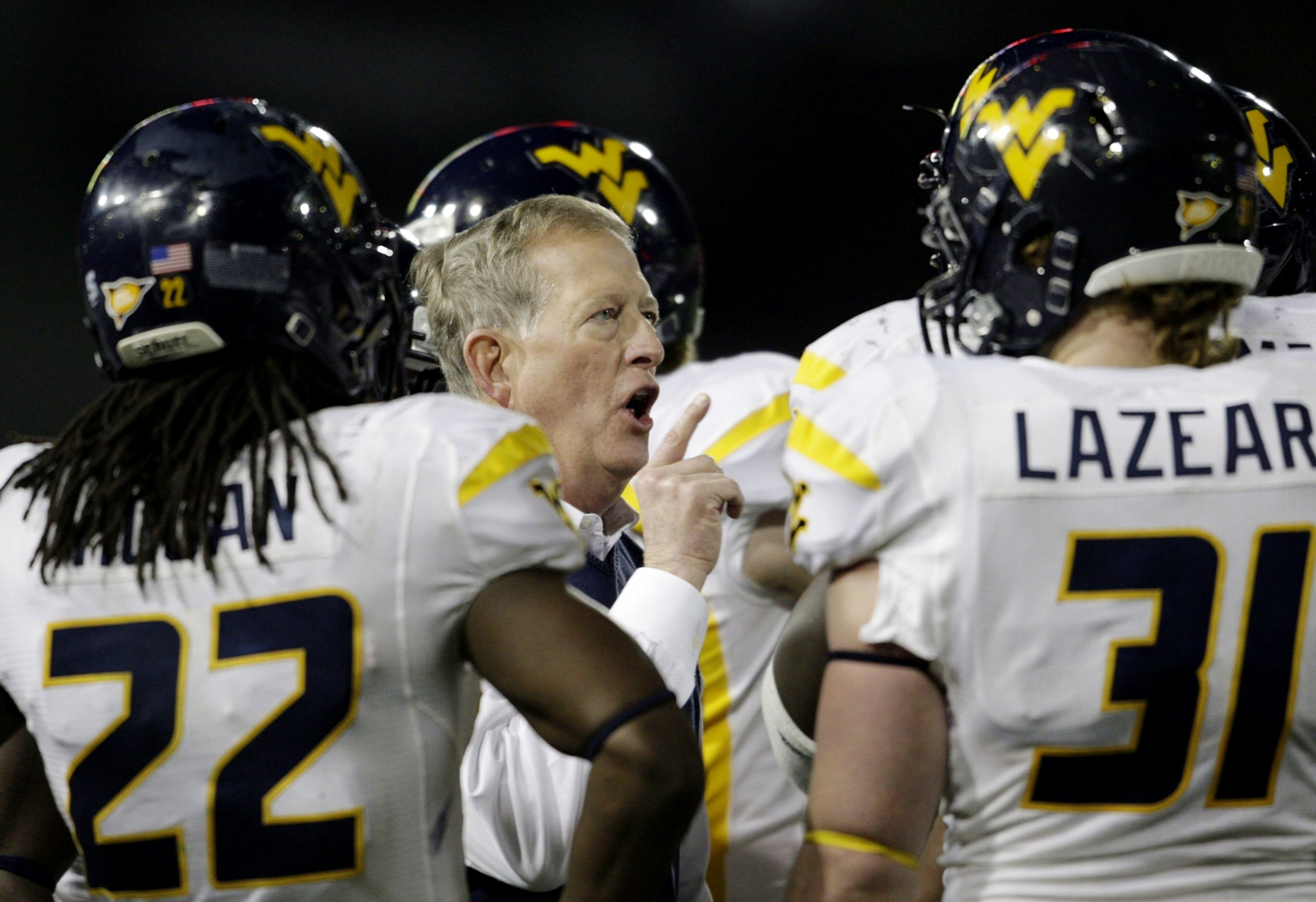 CINCINNATI - NOVEMBER 13: Head coach Bill Stewart of the West Virginia Mountaineers meets with his team in the fourth quarter of the game against the Cincinnati Bearcats at Nippert Stadium on November 13, 2009 in Cincinnati, Ohio. (Photo by Andy Lyons/G CINCINNATI - NOVEMBER 13: Head coach Bill Stewart of the West Virginia Mountaineers meets with his team in the fourth quarter of the game against the Cincinnati Bearcats at Nippert Stadium on November 13, 2009 in Cincinnati, Ohio. (Photo by Andy Lyons/G