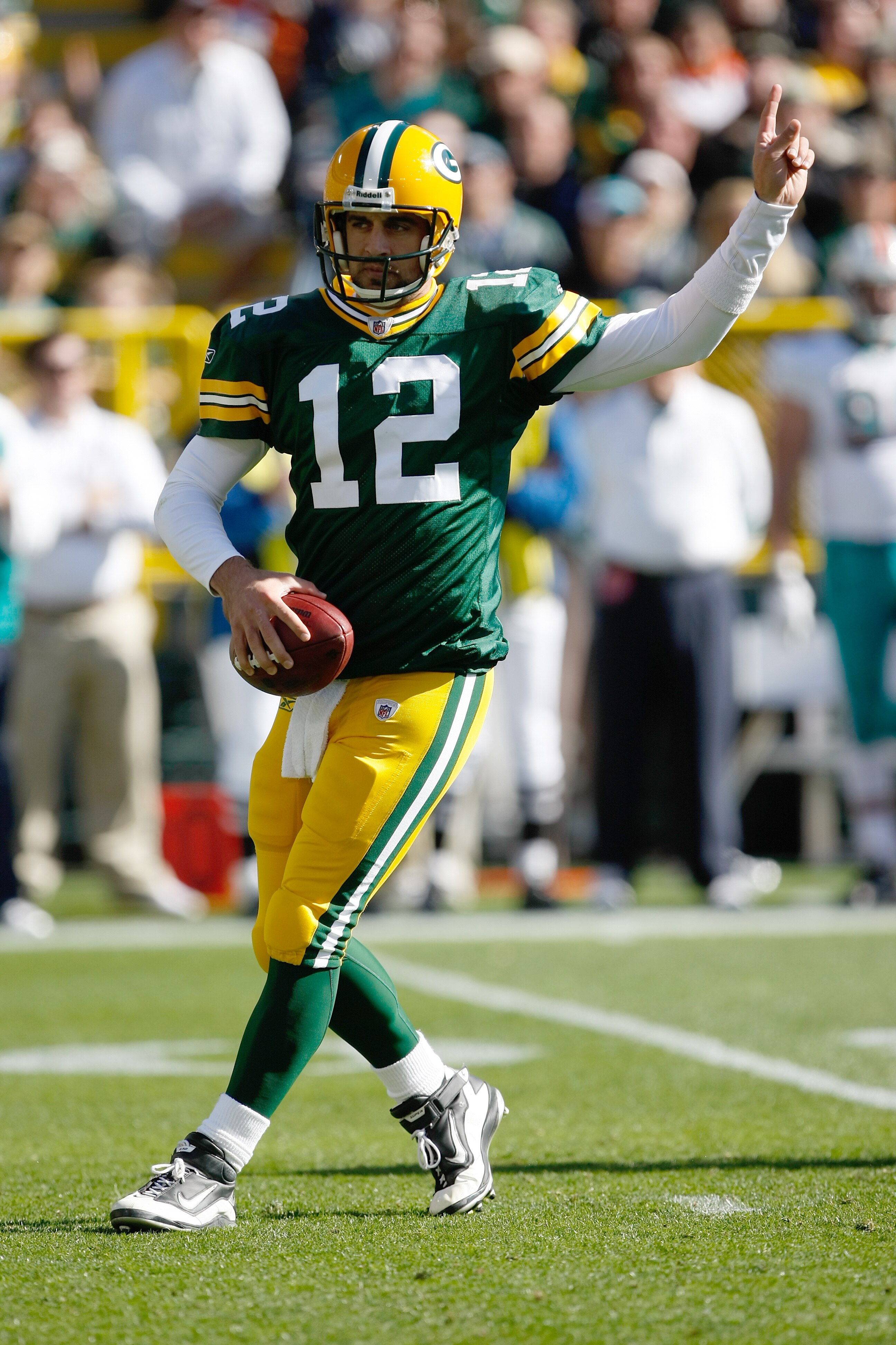 GREEN BAY, WI - OCTOBER 17: Aaron Rogers #12 of the Green Bay Packers points as he drops back to pass against the Miami Dolphins at Lambeau Field on October 17, 2010 in Green Bay, Wisconsin. (Photo by Scott Boehm/Getty Images)