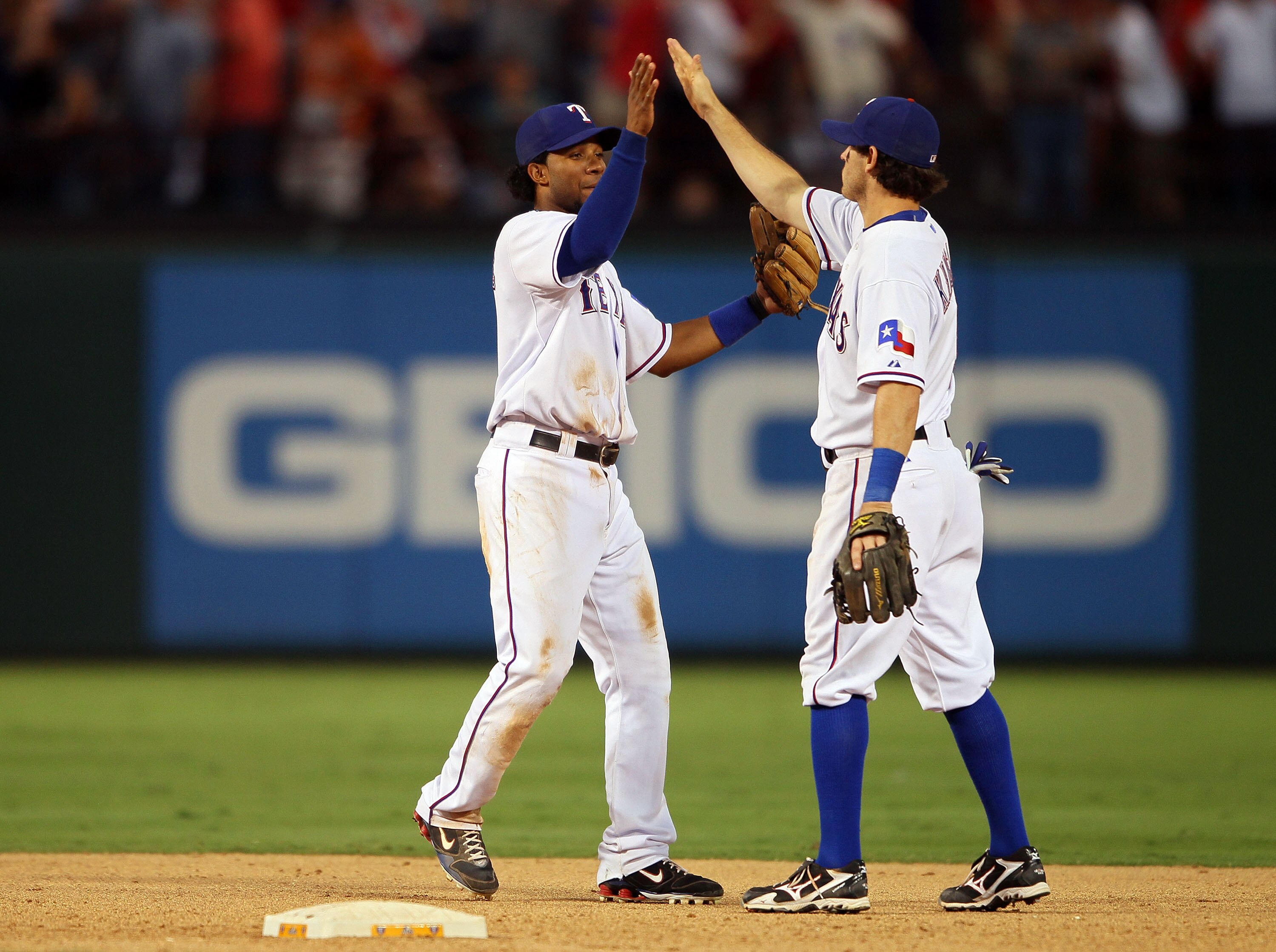 ARLINGTON, TX - OCTOBER 16:  Elvis Andrus #1 and Ian Kinsler #5 of the Texas Rangers celebrate after defeating the New York Yankees by a score of 7-2 to win Game Two of the ALCS during the 2010 MLB Playoffs at Rangers Ballpark in Arlington on October 16,