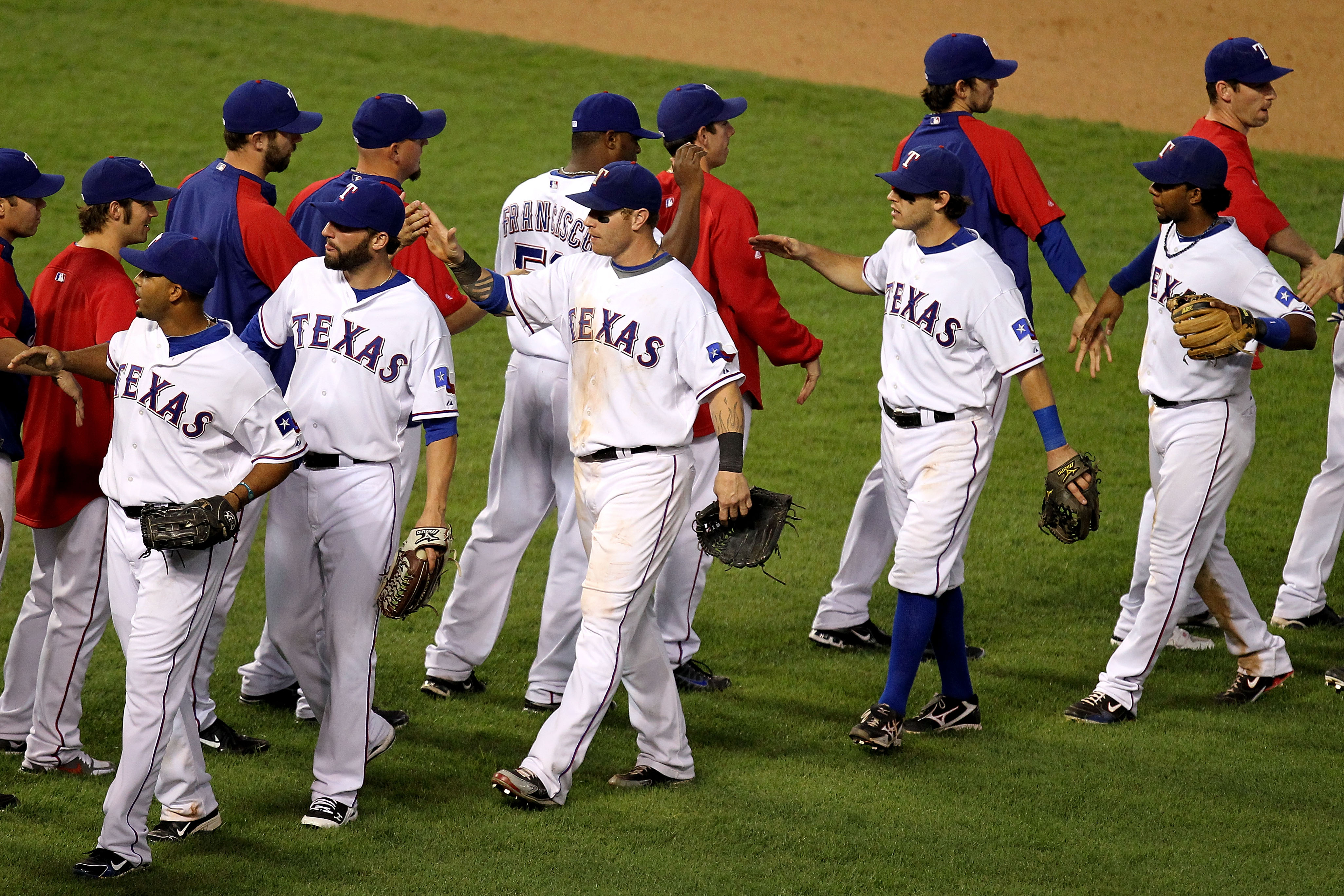 ARLINGTON, TX - OCTOBER 16:  (L-R walking towards L) Nelson Cruz #17, Jeff Francoeur #21, Josh Hamilton #32, Ian Kinsler #5 and Elvis Andrus #1 of the Texas Rangers celebrate with their teammates after they won 7-2 against the New York Yankees against the