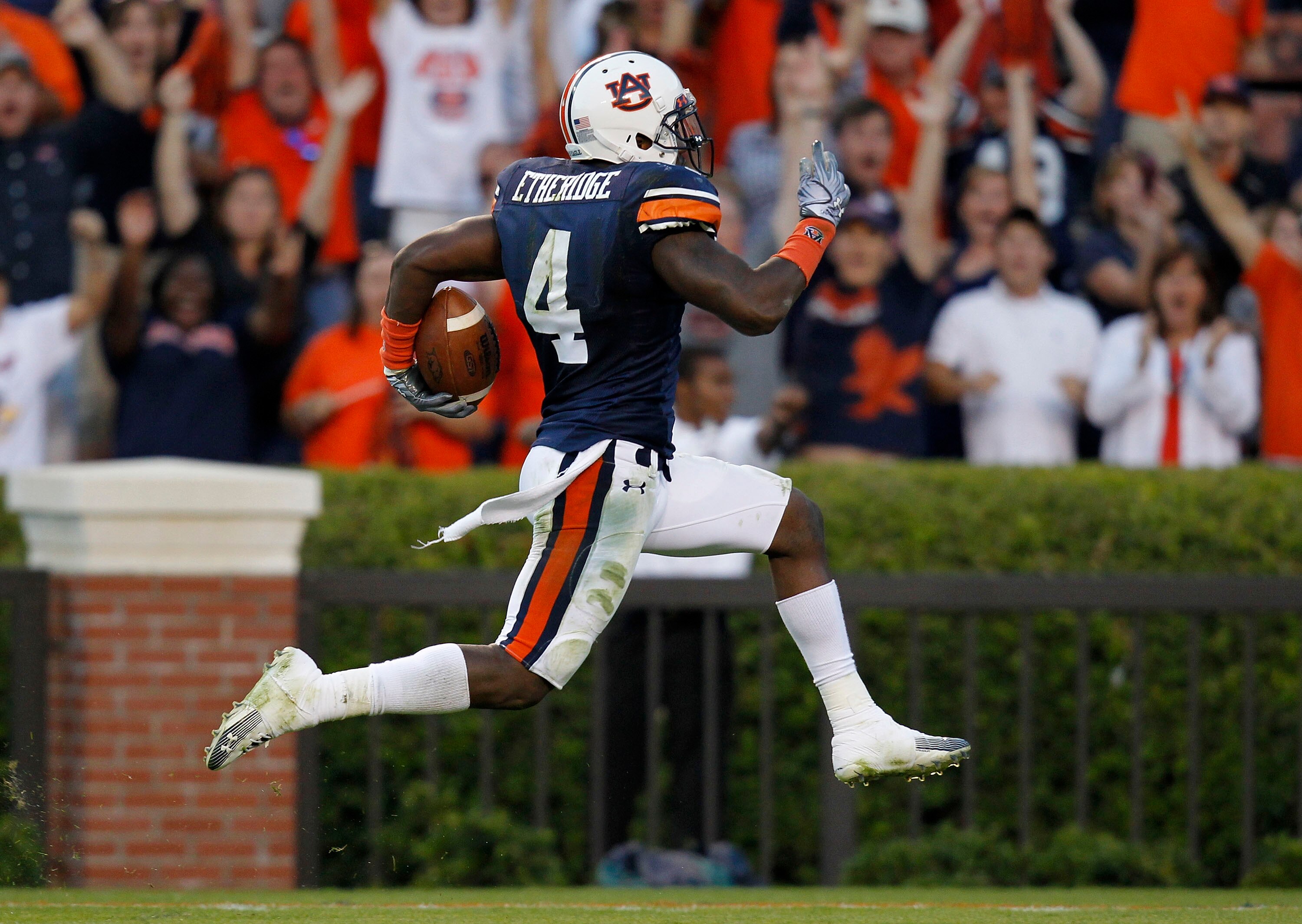 AUBURN - OCTOBER 16:  Safety Zac Etheridge #4 of the Auburn Tigers brings a fumble back for a touchdown during the game against the Arkansas Razorbacks at Jordan-Hare Stadium on October 16, 2010 in Auburn, Alabama.  The Tigers beat the Razorbacks 65-43.