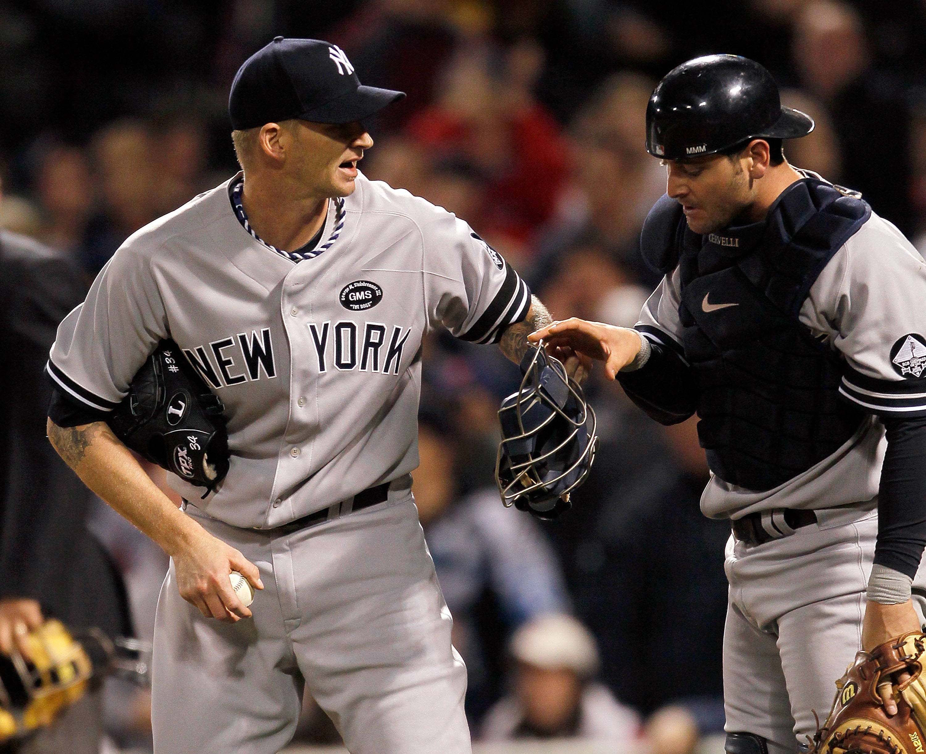 BOSTON - OCTOBER 2: Francisco Cervelli #29  of the New York Yankees confers with A.J. Burnett after Cervelli misplayed a foul popup against the Boston Red Sox in the second game of a doubleheader at Fenway Park, October 2, 2010, in Boston, Massachusetts.