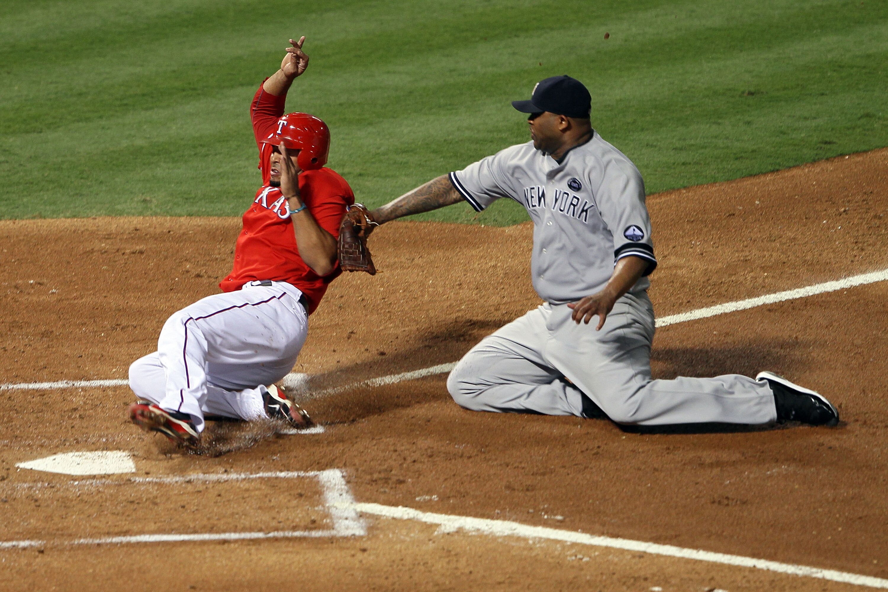 ARLINGTON, TX - OCTOBER 15:  CC Sabathia #52 of the New York Yankees tags out Nelson Cruz #17 of the Texas Rangers at the plate in Game One of the ALCS during the 2010 MLB Playoffs at Rangers Ballpark in Arlington on October 15, 2010 in Arlington, Texas.