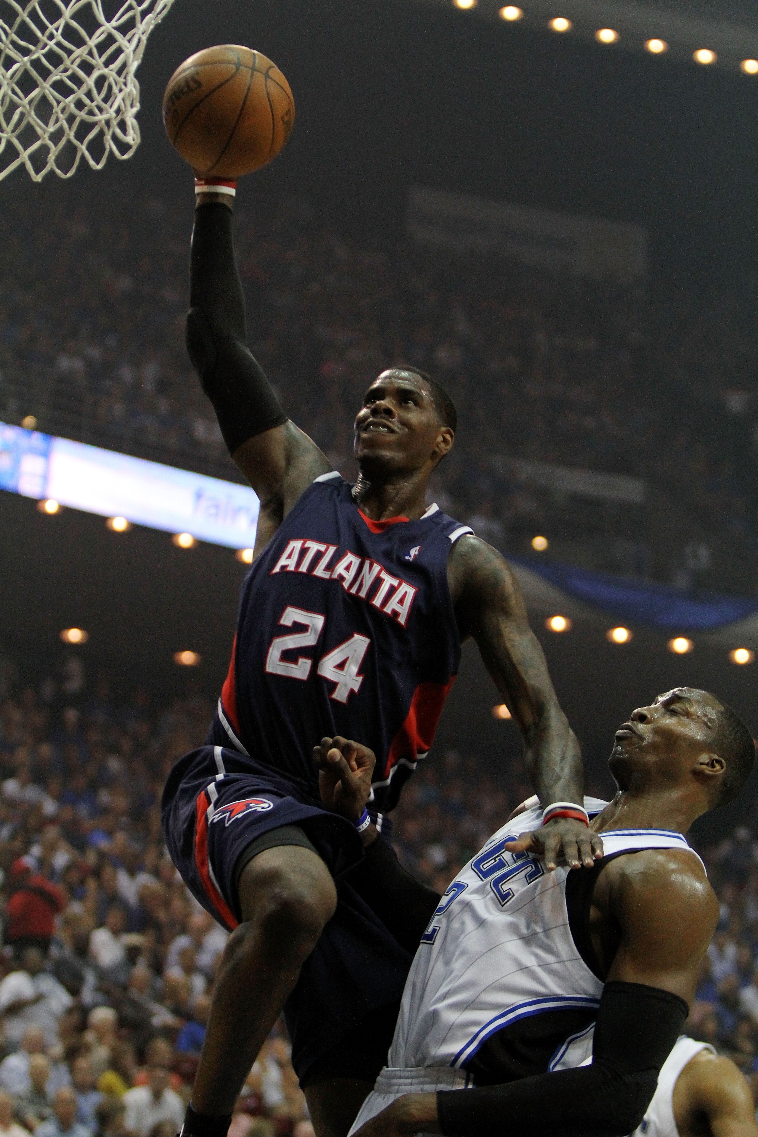 ORLANDO, FL - MAY 06:  Marvin Williams #24 of the Atlanta Hawks scores over Dwight Howard #12 of the Orlando Magic in Game Two of the Eastern Conference Semifinals during the 2010 NBA Playoffs at Amway Arena on May 6, 2010 in Orlando, Florida. NOTE TO USE