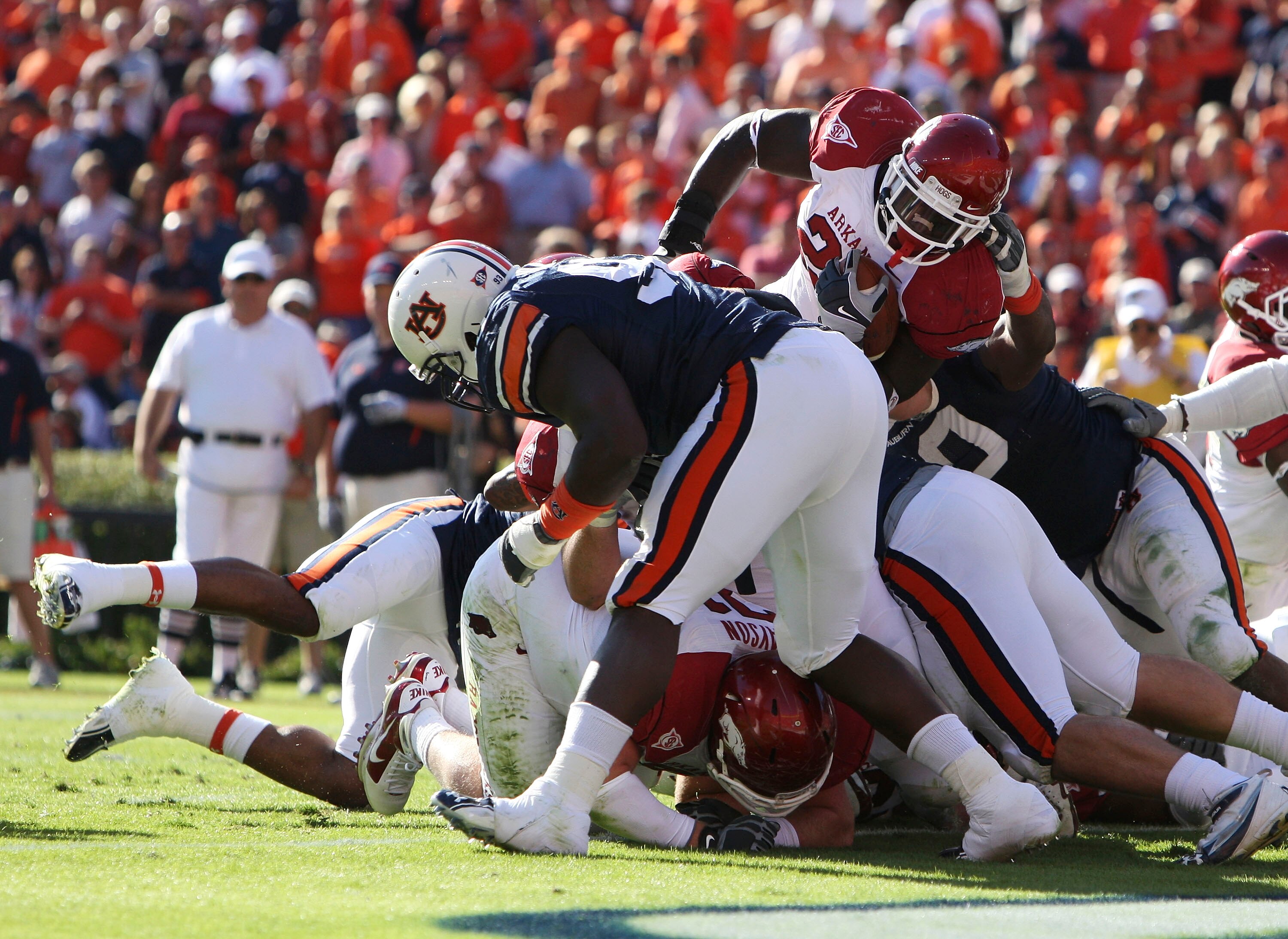 AUBURN - OCTOBER 16:  Running back Broderick Green #29 of the Arkansas Razorbacks (top right) scores a touchdown over the top during the game against the Auburn Tigers at Jordan-Hare Stadium on October 16, 2010 in Auburn, Alabama.  (Photo by Mike Zarrilli