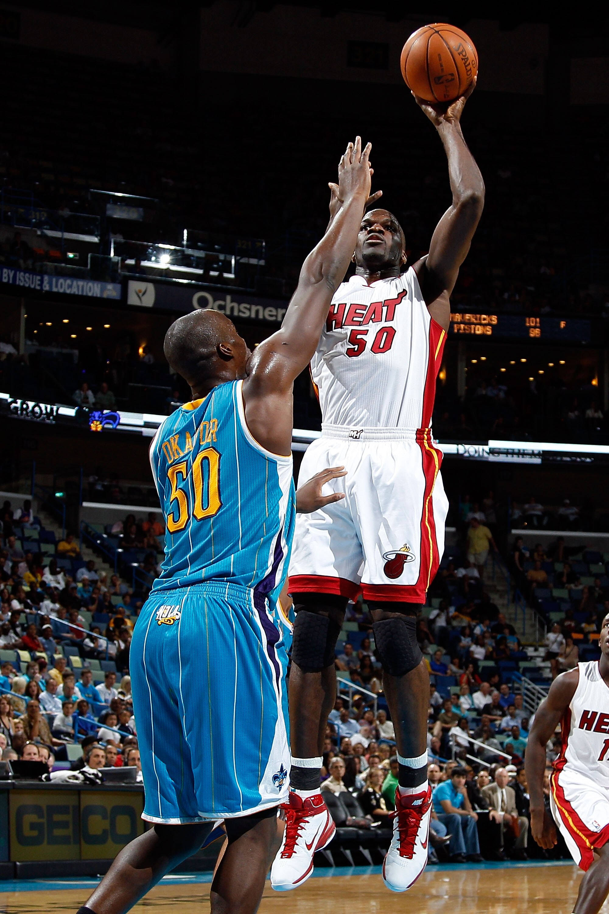 NEW ORLEANS - OCTOBER 13:  Joel Anthony #50 of the Miami Heat shoots the ball over Emeka Okafor #50 of the New Orleans Hornets at the New Orleans Arena on October 13, 2010 in New Orleans, Louisiana.  The Hornets defeated the Heat 90-76.   NOTE TO USER: Us