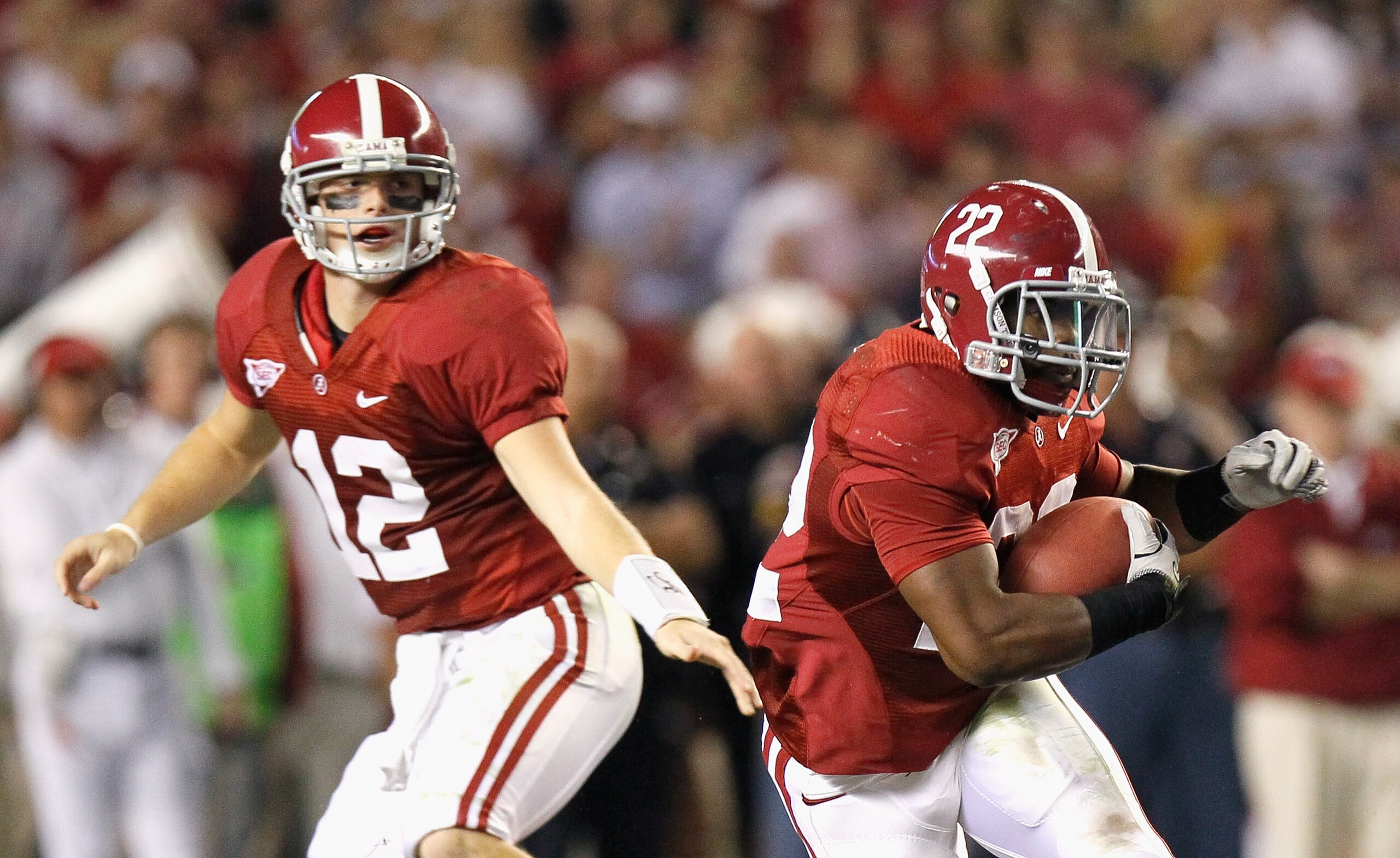 TUSCALOOSA, AL - OCTOBER 16:  Quarterback Greg McElroy #12 of the Alabama Crimson Tide hands the ball off to Mark Ingram #22 against the Ole Miss Rebels at Bryant-Denny Stadium on October 16, 2010 in Tuscaloosa, Alabama.  (Photo by Kevin C. Cox/Getty Imag