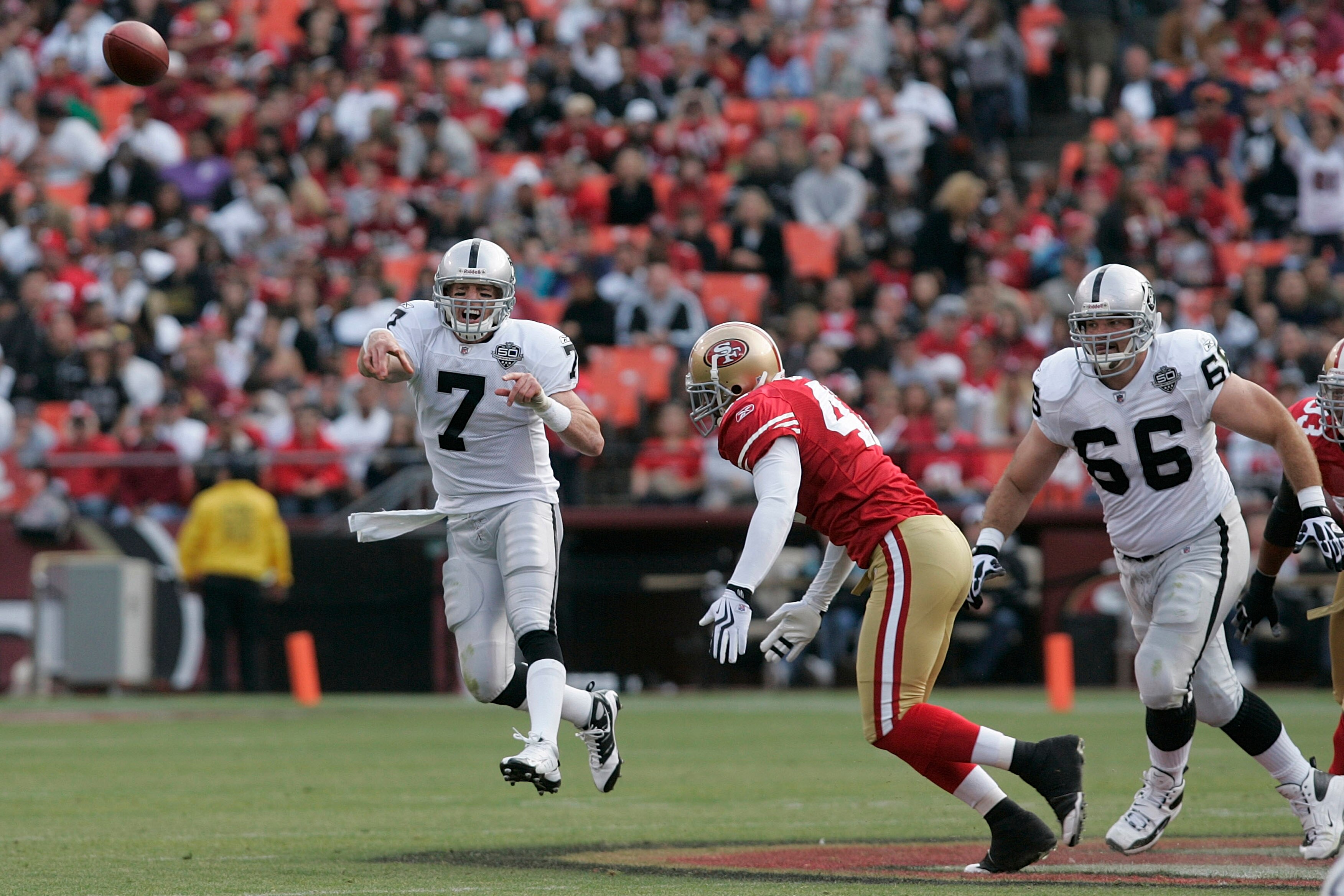 SAN FRANCISCO - AUGUST 22:  Oakland Raiders quarterback Jeff Garcia #7 gets rid of the ball as he is pressured by San Francisco 49ers linebacker Diyral Briggs #47 as Oakland Raiders guard Cooper Carlisle #66 looks on during the 2nd quarter as the San Fran