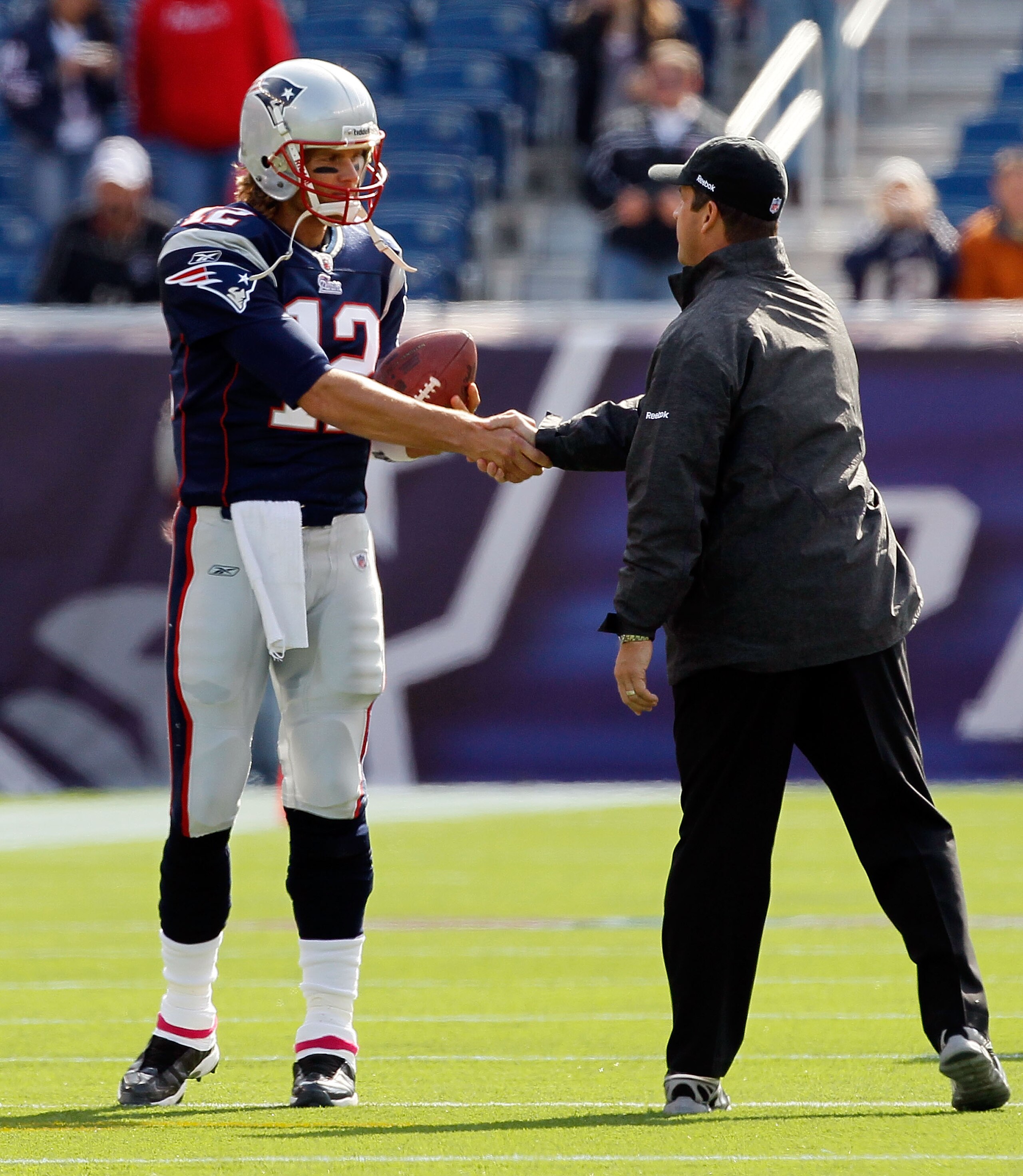 FOXBORO, MA - OCTOBER 17:  Coach John Harbaugh of the Baltimore Ravens hake hand with Tom Brady #12 of the New England Patriots before a game at  at Gillette Stadium on October 17, 2010 in Foxboro, Massachusetts.  (Photo by Jim Rogash/Getty Images)