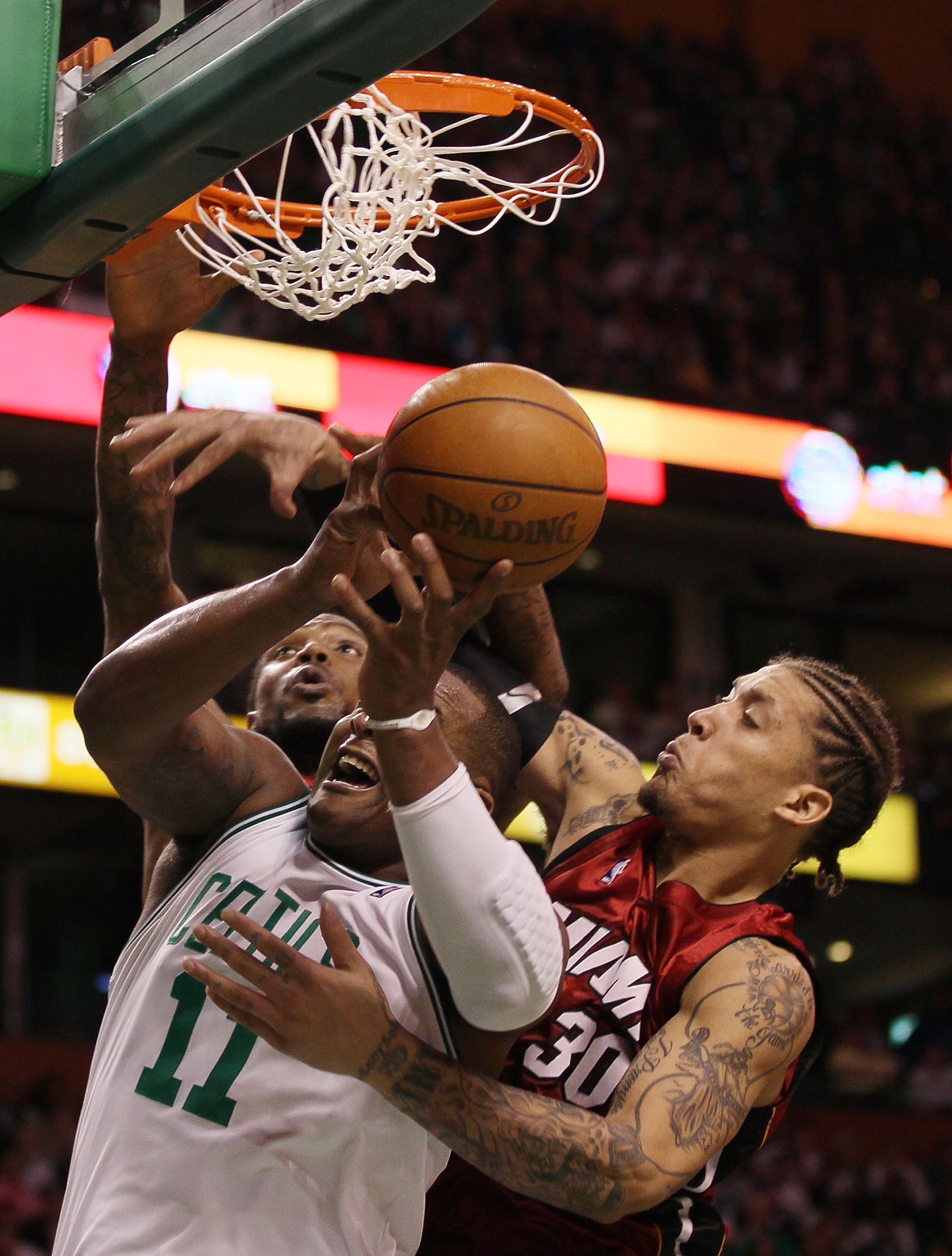 BOSTON - APRIL 20:  Glen Davis #11 of the Boston Celtics fights for the ball with Udonis Haslem #40 and Michael Beasley #30 of the Miami Heat during Game Two of the Eastern Conference Quarterfinals of the 2010 NBA playoffs at the TD Garden on April 20, 20