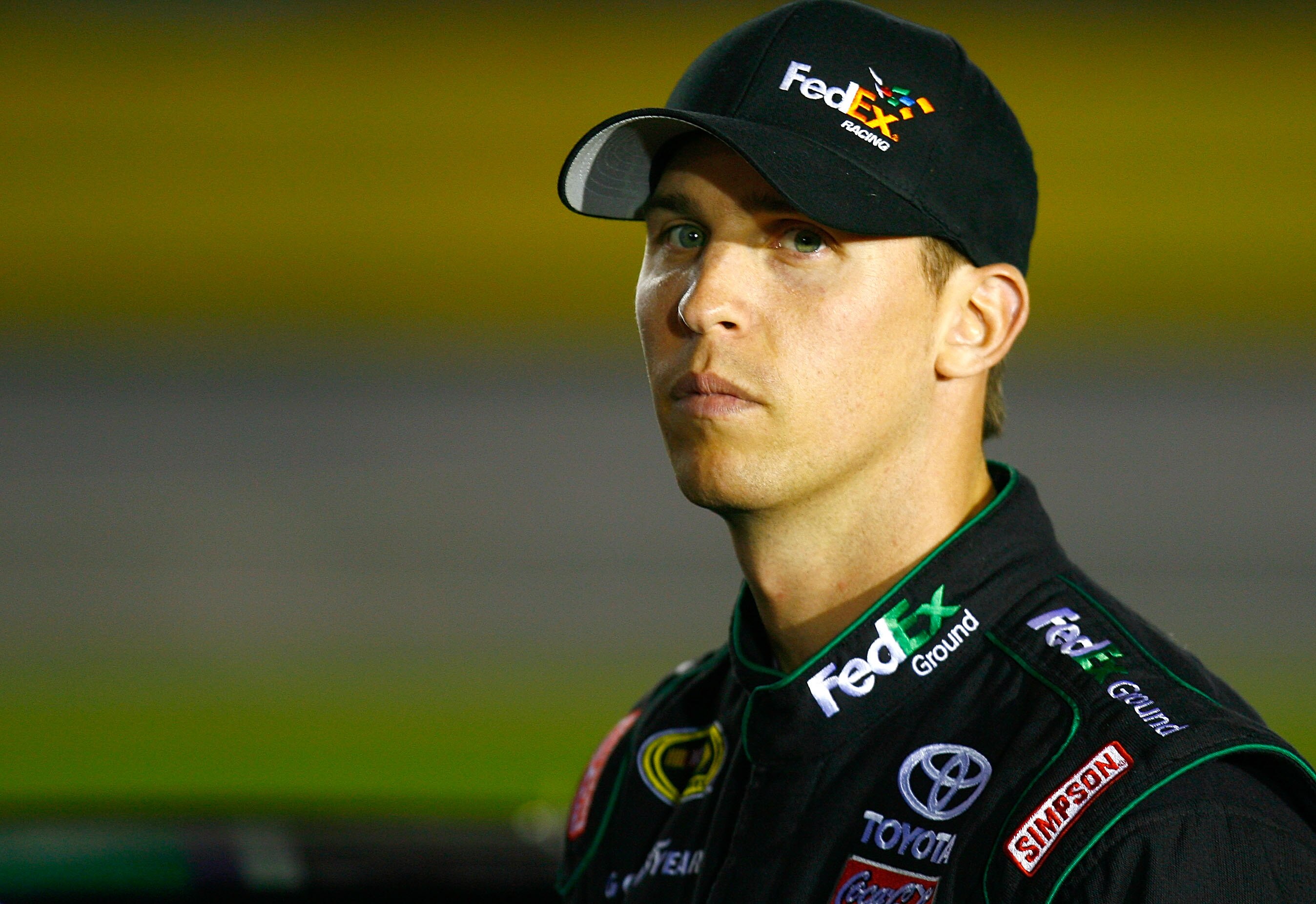 CONCORD, NC - OCTOBER 14:  Denny Hamlin, driver of the #11 FedEx Ground Toyota, stands on pit road during qualifying for the NASCAR Sprint Cup Series Bank of America 500 at Charlotte Motor Speedway on October 14, 2010 in Concord, North Carolina.  (Photo b