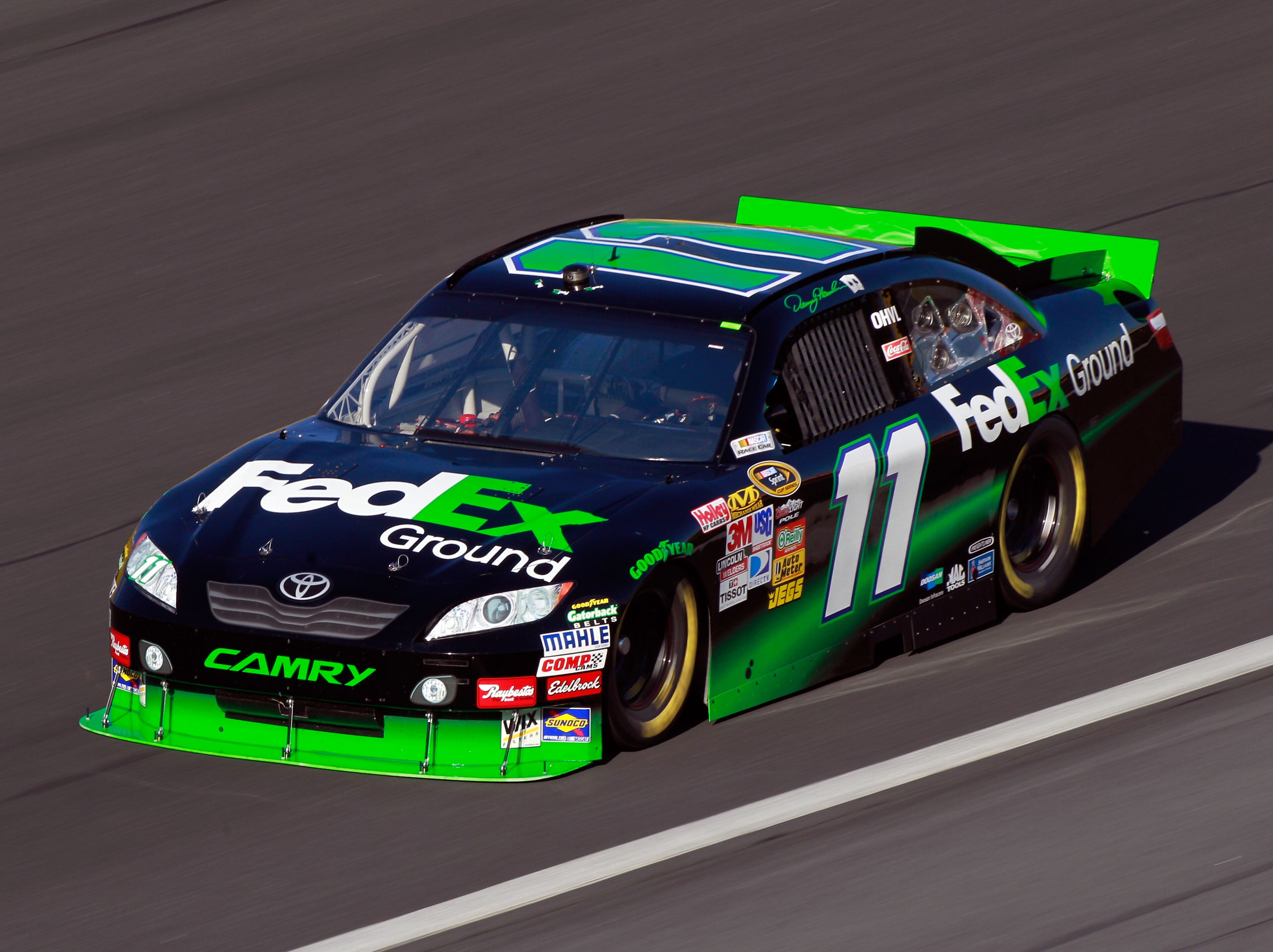 CONCORD, NC - OCTOBER 15:  Denny Hamlin drives the #11 FedEx Ground Toyota during practice for the NASCAR Sprint Cup Series Bank of America 500 at Charlotte Motor Speedway on October 15, 2010 in Concord, North Carolina.  (Photo by Sam Greenwood/Getty Imag