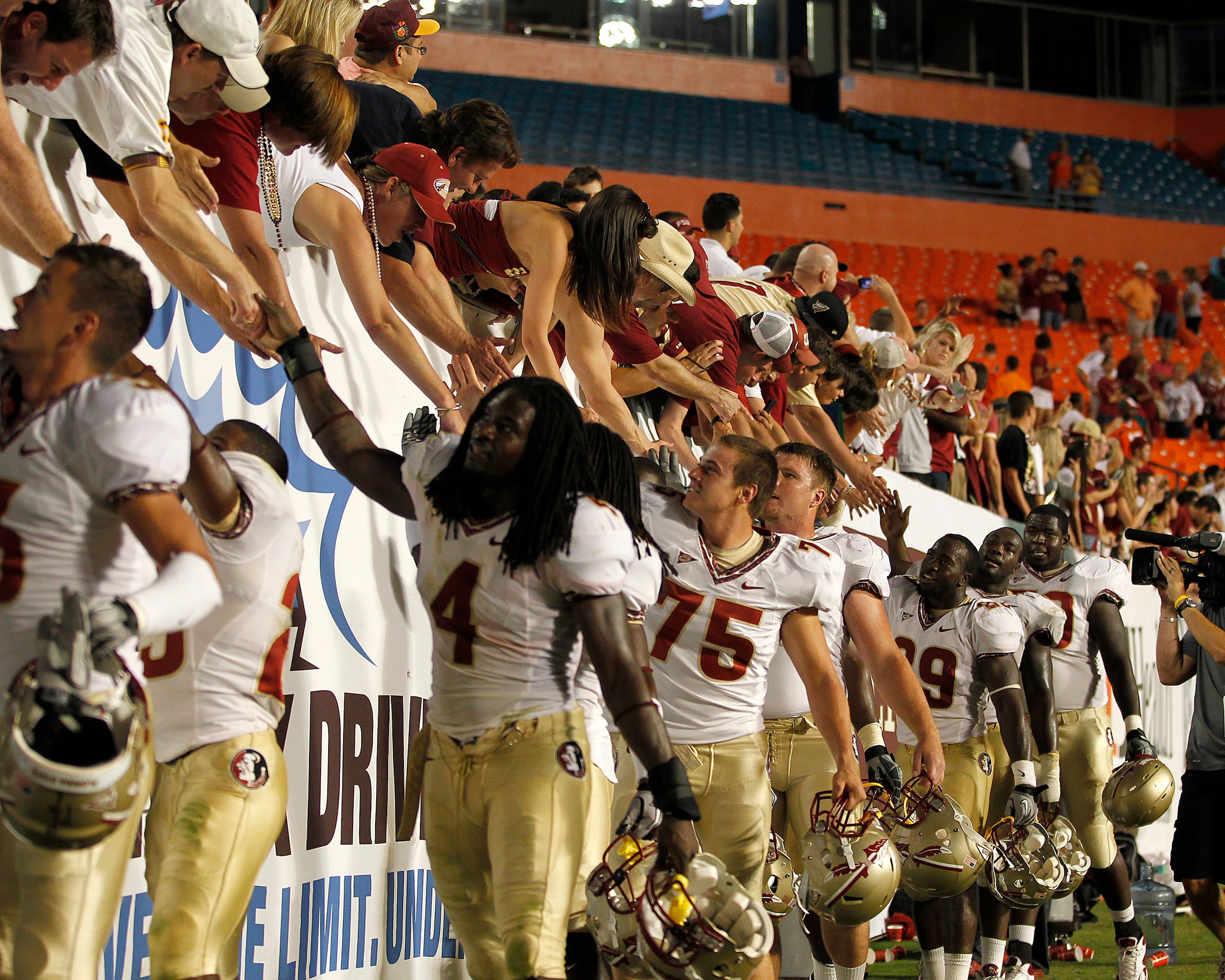 MIAMI, FL - OCTOBER 9: Florida State Seminoles fans celebrate the 45-17 victory against the Miami Hurricanes with members of the team on October 9, 2010 at Sun Life Stadium in Miami, Florida. (Photo by Joel Auerbach/Getty Images)