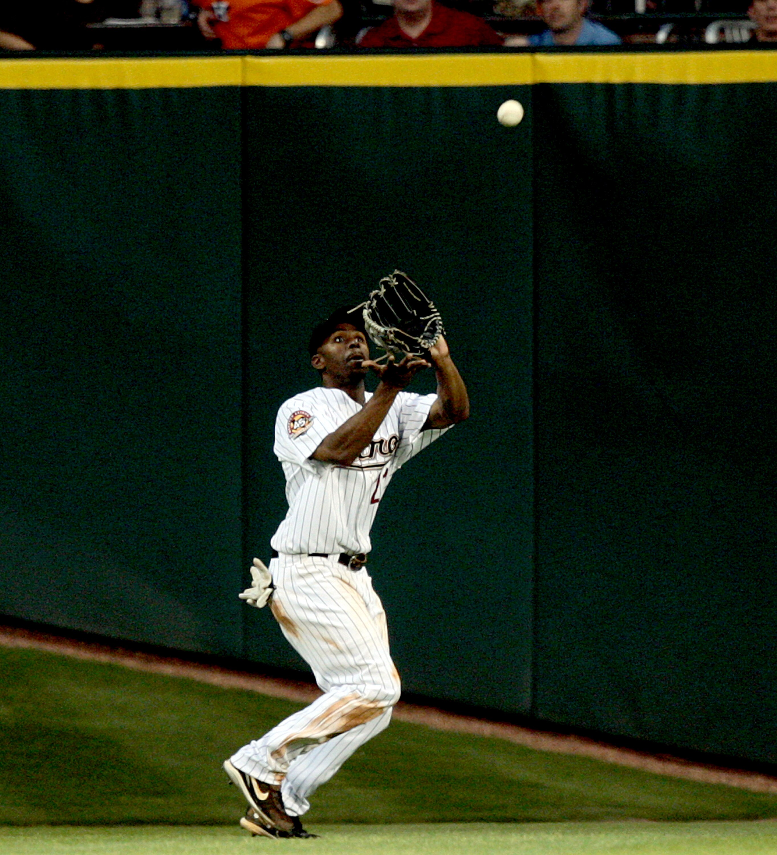 HOUSTON - MAY 03:  Center fielder Michael Bourn #21 of the Houston Astros makes a catch against the Arizona Diamondbacks at Minute Maid Park on May 3, 2010 in Houston, Texas.  (Photo by Bob Levey/Getty Images)