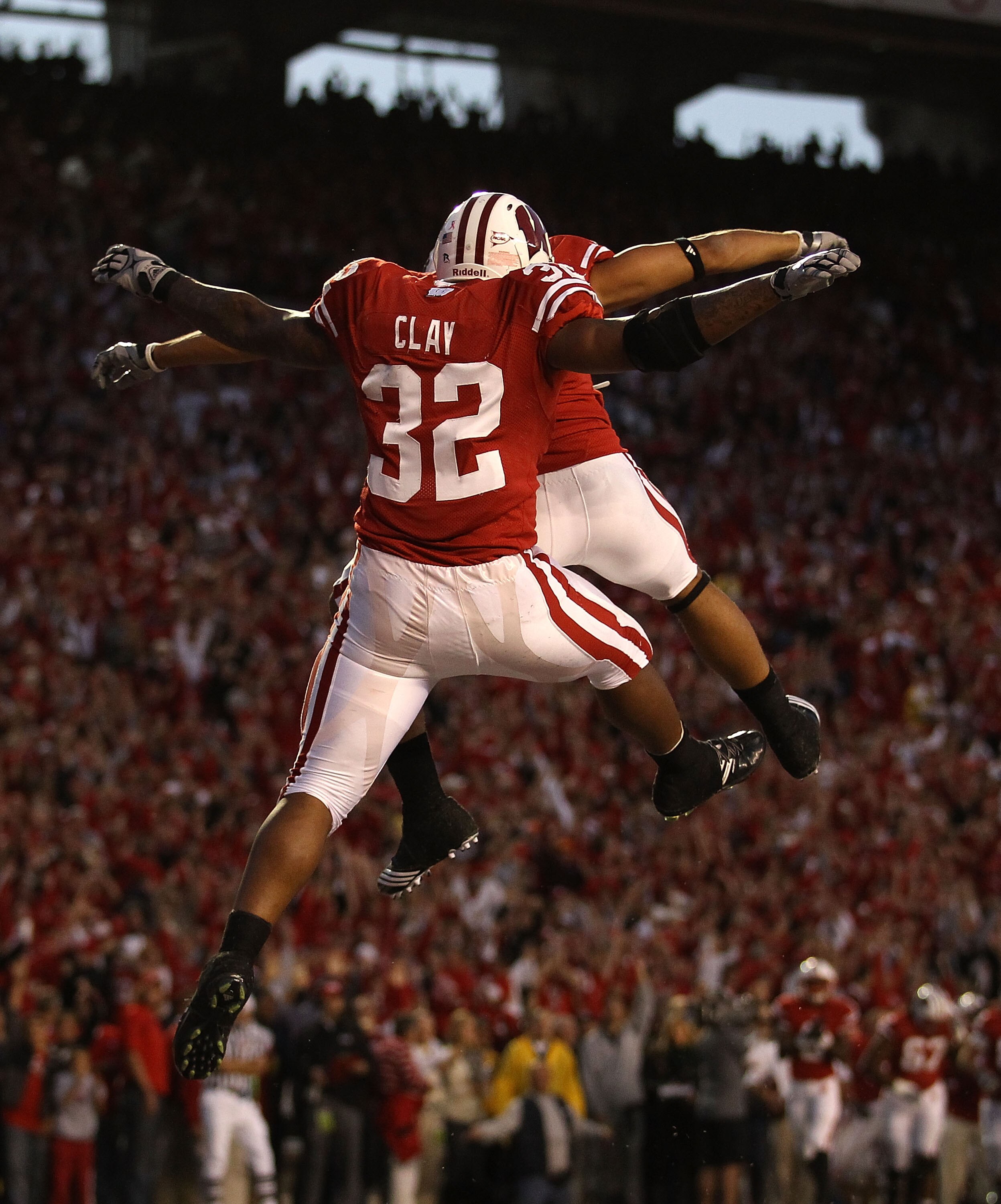 MADISON, WI - OCTOBER 16: John Clay #32 of the Wisconsin Badgers leaps to celebrate a touchdown against the Ohio State Buckeyes with teammate Nick Toon #1 at Camp Randall Stadium on October 16, 2010 in Madison, Wisconsin. (Photo by Jonathan Daniel/Getty I