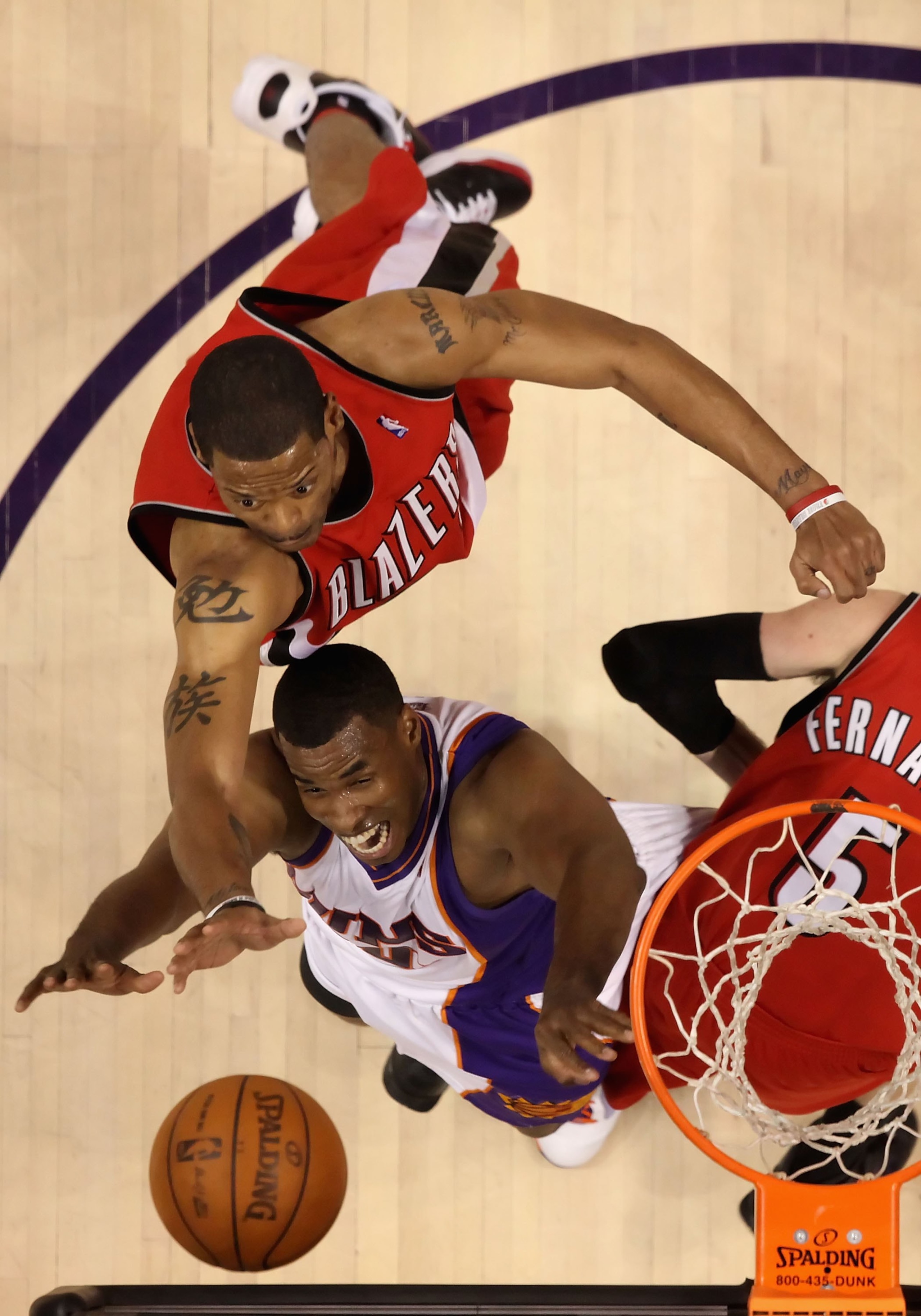 PHOENIX - APRIL 18:  Marcus Camby #21 of the Portland Trail Blazers and Jarron Collins #20 of the Phoenix Suns battle for a rebound during Game One of the Western Conference Quarterfinals of the 2010 NBA Playoffs at US Airways Center on April 18, 2010 in