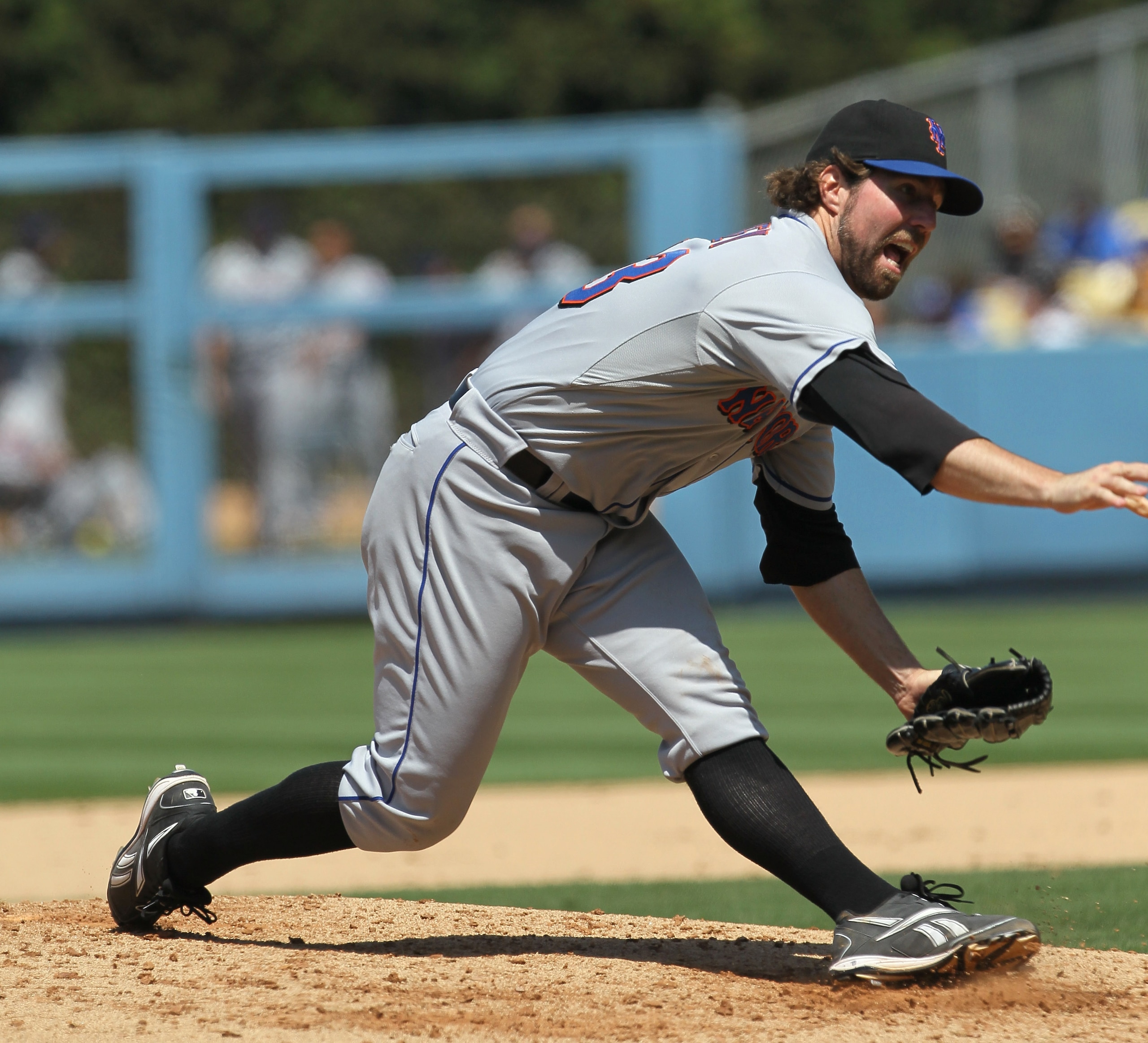 LOS ANGELES, CA - JULY 25:  R.A. Dickey #43 of the New York Mets slips as he catches his left foot in the dirt as he delivers a pitch in the sixth inning against  the Los Angeles Dodgers on July 25, 2010 at Dodger Stadium in Los Angeles, California. Dicke