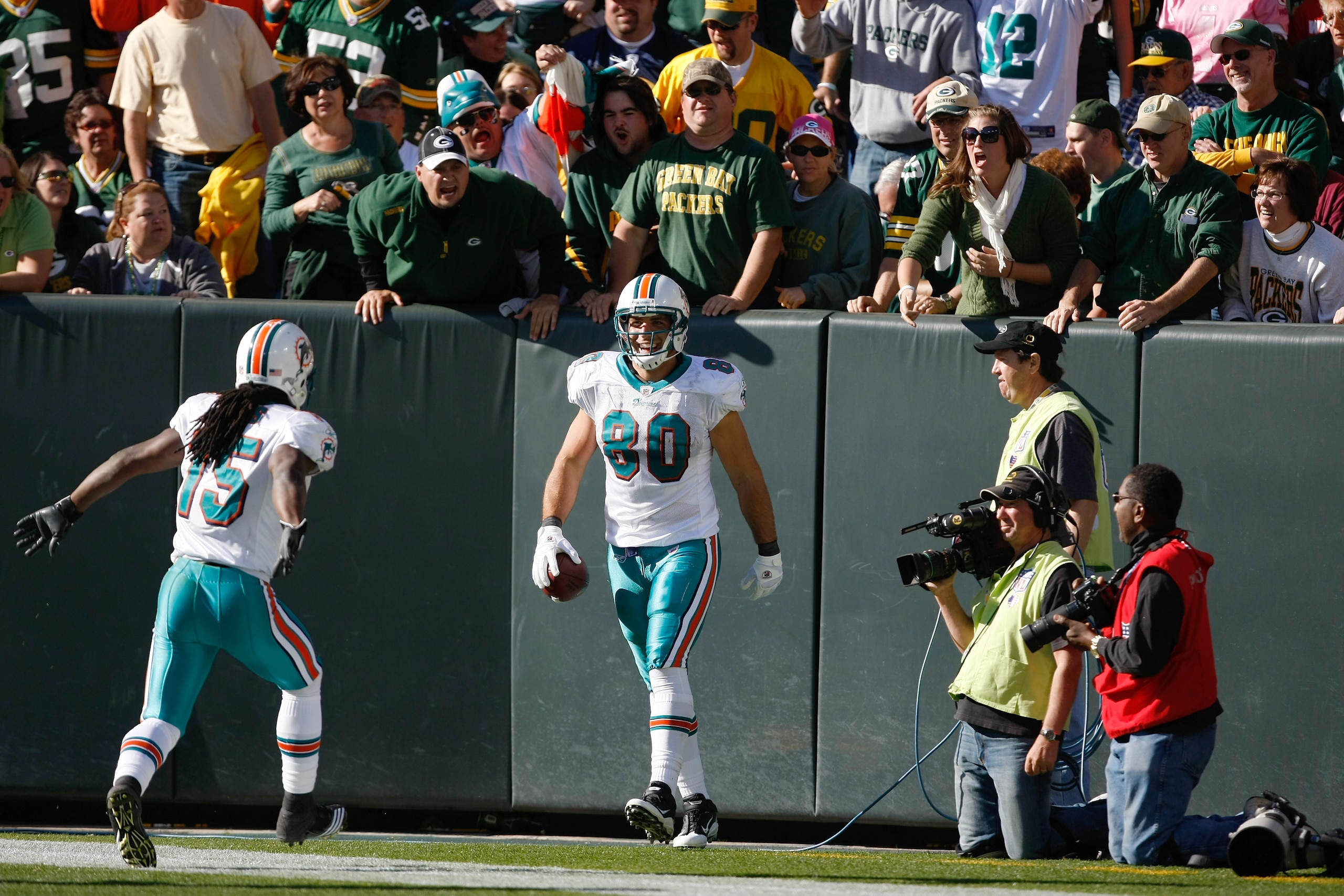 GREEN BAY, WI - OCTOBER 17: Anthony Fasano #80 of the Miami Dolphins celebrates a touchdown against the Green Bay Packers at Lambeau Field on October 17, 2010 in Green Bay, Wisconsin. The Dolphins defeated the Packers 23-20 in overtime. (Photo by Scott Bo