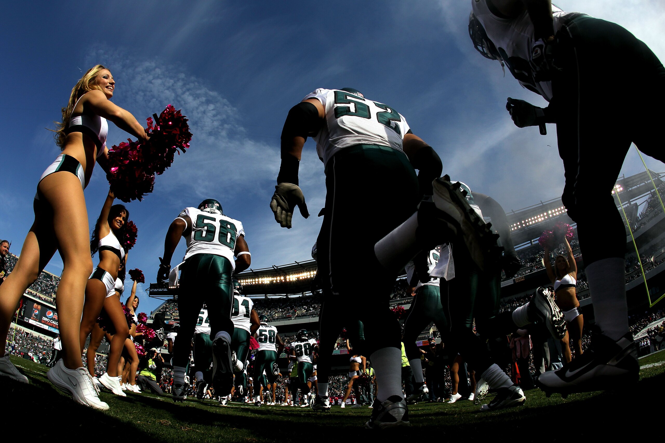 PHILADELPHIA - OCTOBER 17:  A Philadelphia Eagles cheerleader greets the Eagles as they take the field against the Atlanta Falcons during their game at Lincoln Financial Field on October 17, 2010 in Philadelphia, Pennsylvania.  (Photo by Al Bello/Getty Im